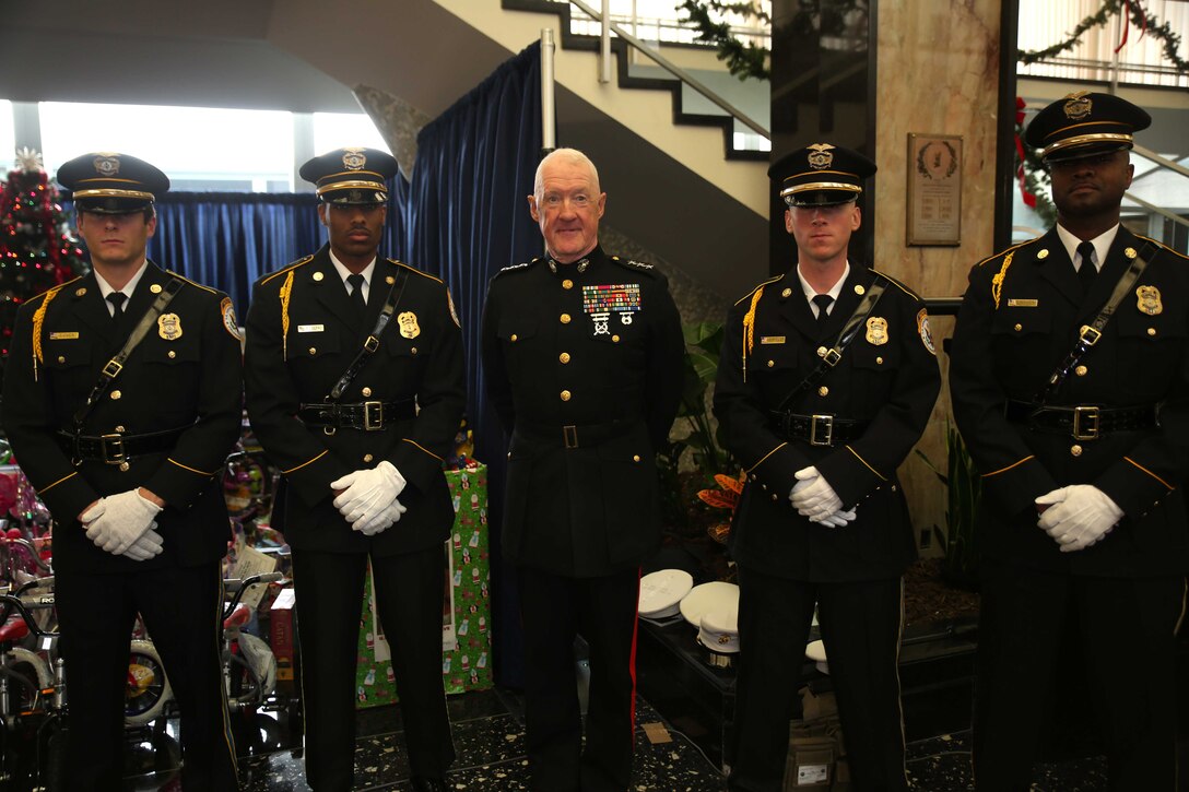 Lt. Gen. Richard P. Mills, commander of Marine Forces Reserve, stands with the Department of State honor guard during a Toys for Tots event at the U.S. State Department building Dec. 9, 2014. Secretary of State John Kerry was also present and was presented with a Toys for Tots plaque as a thank you from Marine Corps Forces Reserve for collecting so many toys. 