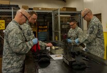 Participants in the 647th Security Forces Squadron Combat Arms Training and Maintenance Flight elementary level Excellence in Competition Pistol Match clean their weapons after the completion at the Air Force shooting range on Schofield Barracks, Hawaii, Dec. 11, 2014. For the competition, the participants were asked to fire a 9MM one handed and two handed with variations for the best overall score. The top 10 percent of the participants walked away with bragging rights, and the authorization to wear the Elementary Excellence in Competition Pistol Badge on their ribbon racks. (U.S. Air Force photo by Tech. Sgt. Terri Paden/RELEASED)