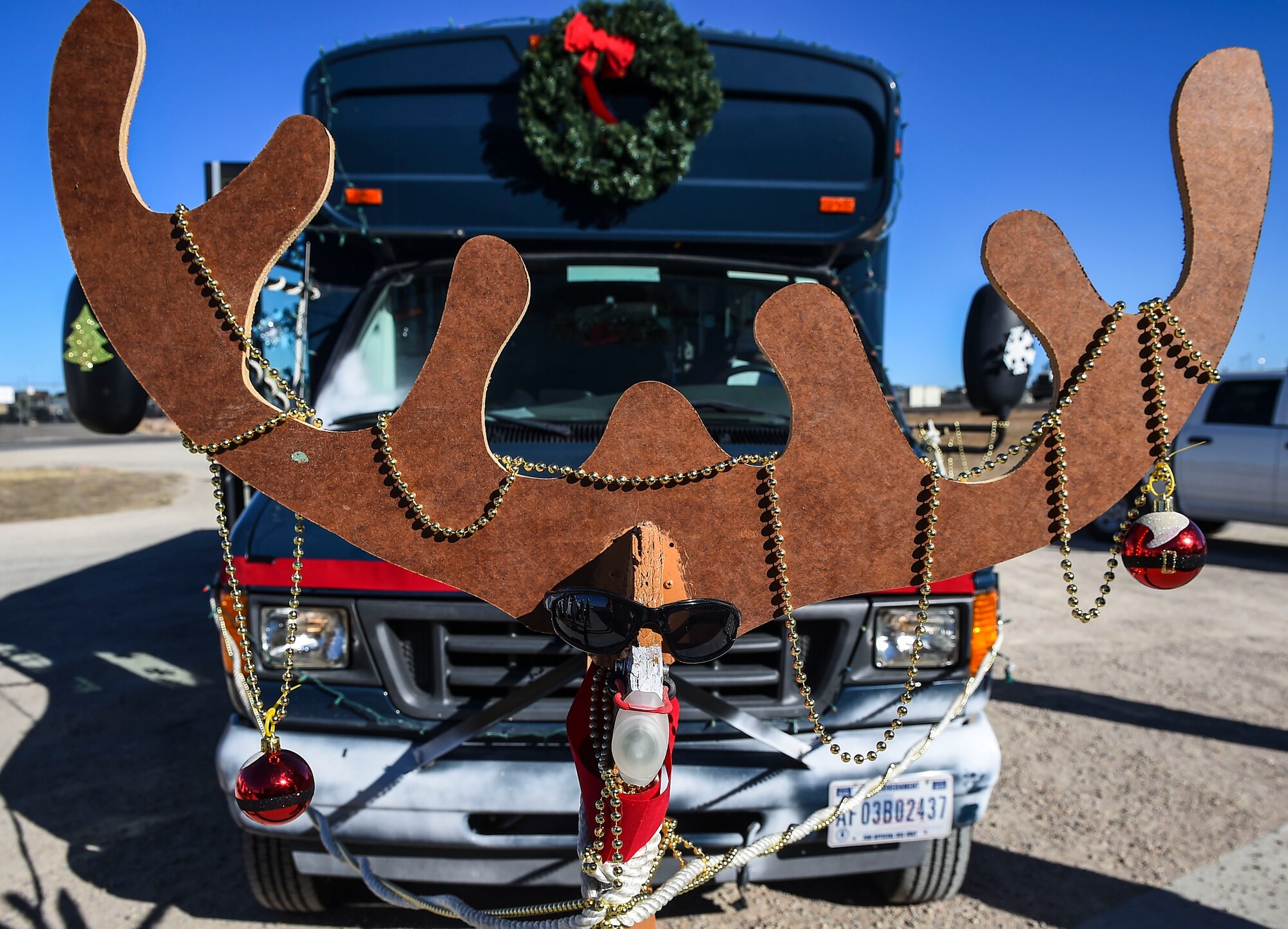 Members of the 460th Mission Support Group drove around base on a decorated bus and gave food to 460th MSG agency members Dec. 11, 2014, on Buckley Air Force Base, Colo. During their route, the holiday party bus crew made stops at 19 support group work areas while distributing food and holiday greetings. Some of the 460th MSG agencies the bus visited were the fire department, outdoor recreation and child development centers and security forces, civil engineer, and force support squadrons. (U.S. Air Force photo by Senior Airman Riley Johnson/Released)