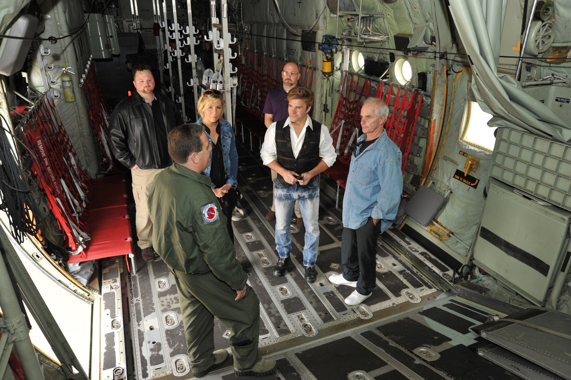 Master Sgt. Jeff Stack, 53rd Weather Reconnaissance Squadron dropsonde operator, briefs actors Jack Stauffer, Battlestar Galactica, Vic Mignogna, an anama voice actor, and Gigi Edgley, Farscape, about the Hurricane Hunter mission and WC-130J.  The actors stopped by the wing for an aircraft tour before making their guest appearances at the Geek-O-Nomicon convention at the Mississippi Coast Coliseum and Convention Center Dec. 12-14, 2014. (U.S. Air Force photo/Maj. Marnee A.C. Losurdo)