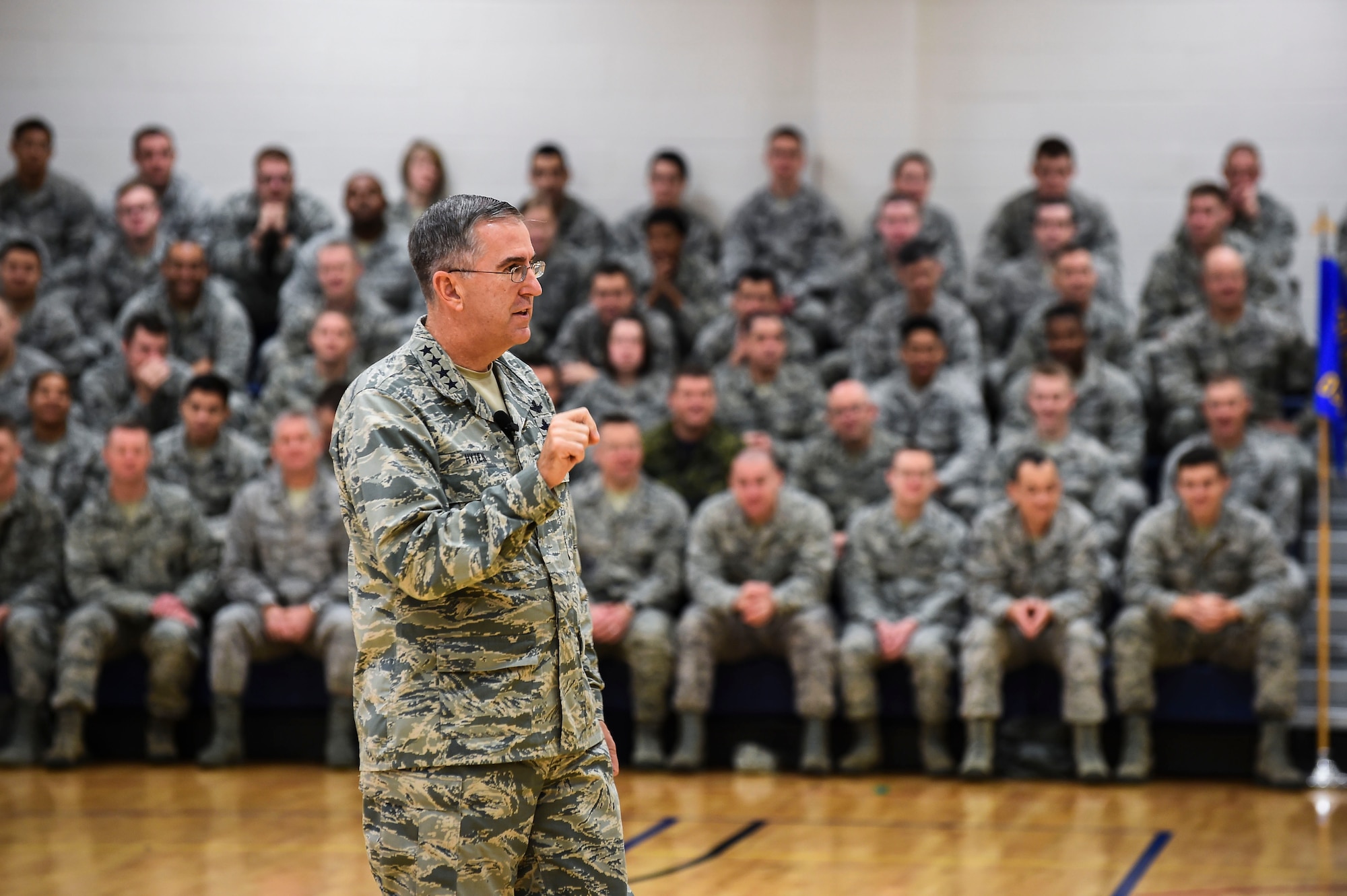 General John E. Hyten, Commander of Air Force Space Command, speaks to 460th Space Wing Airmen Dec. 10, 2014, in the fitness center on Buckley Air Force Base, Colo. During General Hyten’s first visit to Buckley after assuming AFSPC command Aug 2014, he received a mission brief, toured the 460th Operations Group Mission Control Station and spoke with Airmen at a commander’s call. AFSPC provides space and cyberspace capabilities for the joint force and the nation, and the 460th SW is one of several units in Colorado and around the world that supports AFSPC’s mission. (U.S. Air Force photo by Senior Airman Riley Johnson/Released)