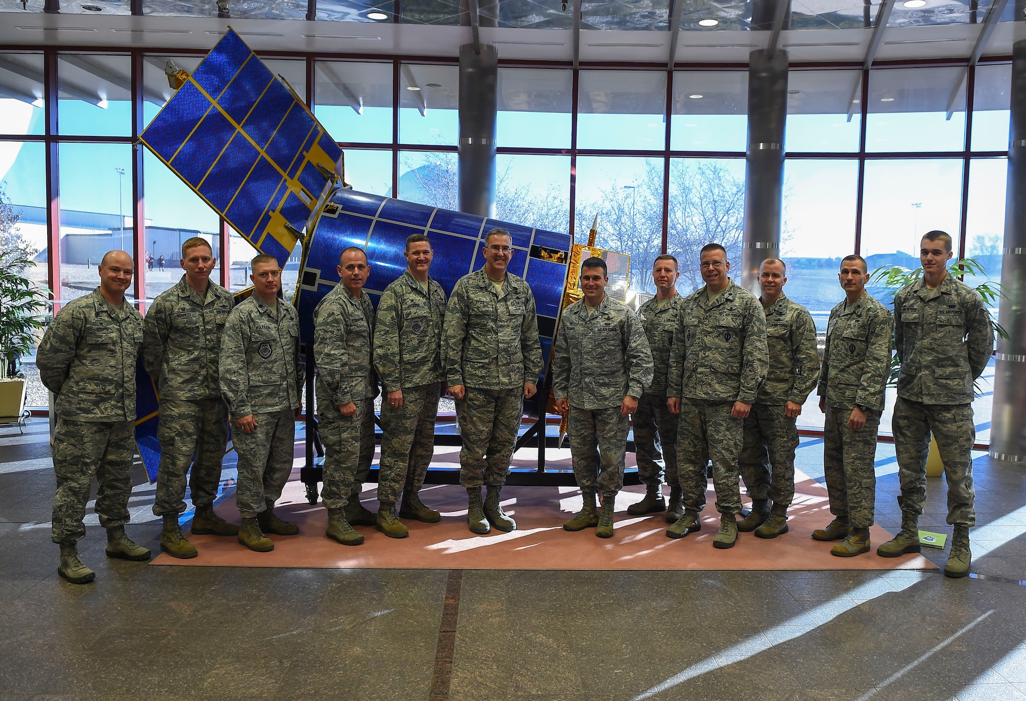 General John E. Hyten, Commander of Air Force Space Command, center left, poses for a group photo with 460th Space Wing Airmen Dec. 10, 2014, in the 460th Operations Group Mission Control Station on Buckley Air Force Base, Colo. During General Hyten’s first visit to Buckley after assuming AFSPC command Aug 2014, he received a mission brief, toured the mission control station and spoke with Airmen at a commander’s call. AFSPC provides space and cyberspace capabilities for the joint force and the nation, and the 460th SW is one of several units in Colorado and around the world that supports AFSPC’s mission. (U.S. Air Force photo by Senior Airman Riley Johnson/Released)