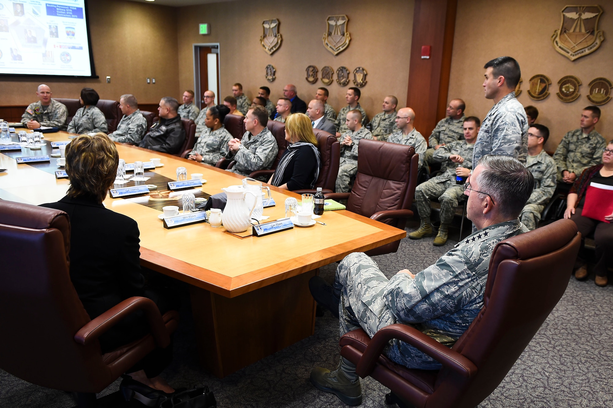Col. John Wagner, 460th Space Wing commander, standing, provides General John E. Hyten, Commander of Air Force Space Command, the 460th SW mission brief Dec. 10, 2014, in the 460th SW conference room on Buckley Air Force Base, Colo. During General Hyten’s first visit to Buckley after assuming AFSPC command Aug 2014, he received a mission brief, toured the 460th Operations Group Mission Control Station and spoke with Airmen at a commander’s call. AFSPC provides space and cyberspace capabilities for the joint force and the nation, and the 460th SW is one of several units in Colorado and around the world that supports AFSPC’s mission. (U.S. Air Force photo by Senior Airman Riley Johnson/Released)