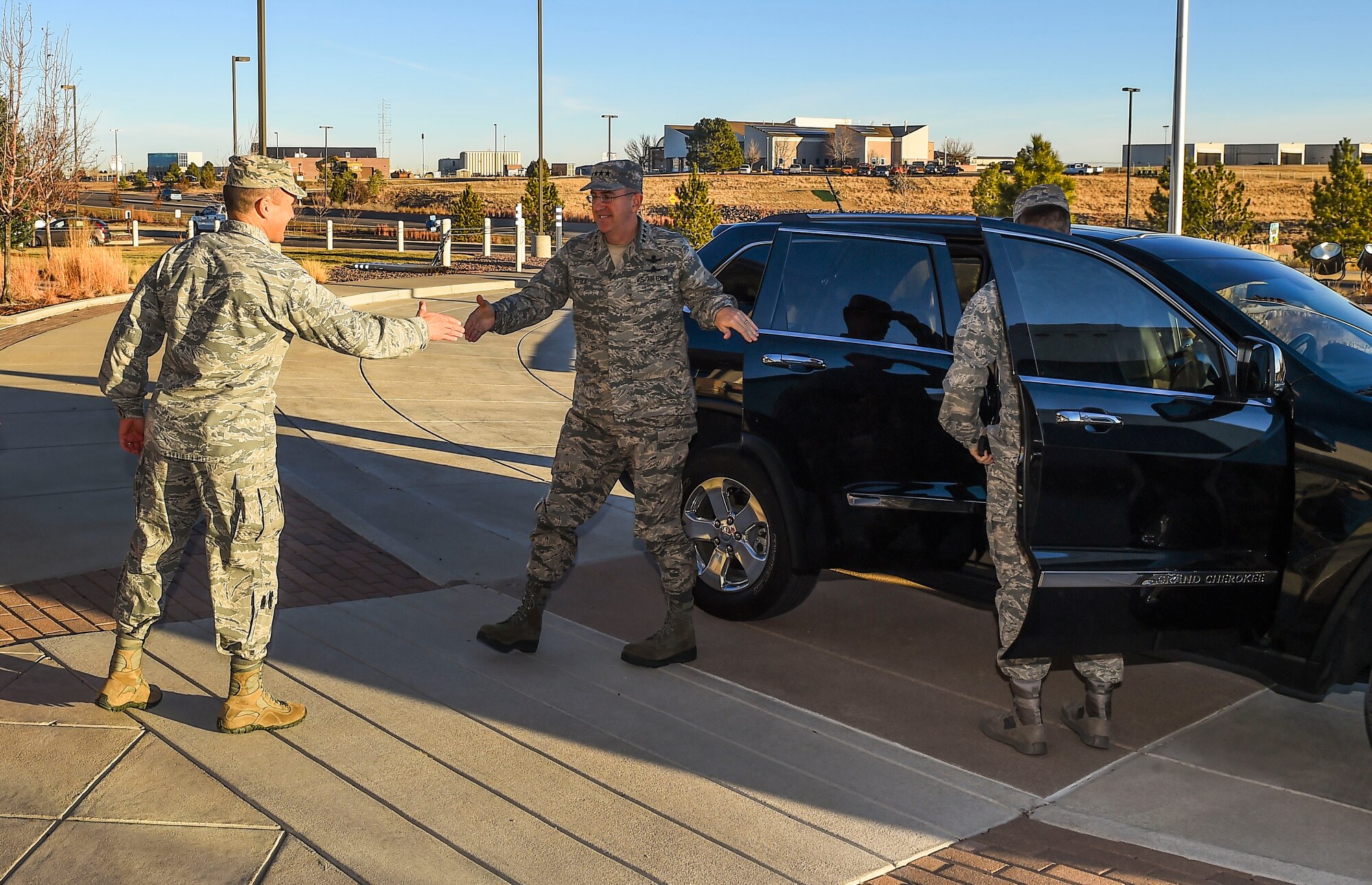 Col. John Wagner, 460th Space Wing commander, left, greets General John E. Hyten, Commander of Air Force Space Command, Dec. 10, 2014, in front of the 460th SW headquarters on Buckley Air Force Base, Colo. During General Hyten’s first visit to Buckley after assuming AFSPC command Aug 2014, he received a mission briefing, toured the 460th Operations Group Mission Control Station and spoke with Airmen at a commander’s call. AFSPC provides space and cyberspace capabilities for the joint force and the nation, and the 460th SW is one of several units in Colorado and around the world that supports AFSPC’s mission. (U.S. Air Force photo by Senior Airman Riley Johnson/Released)