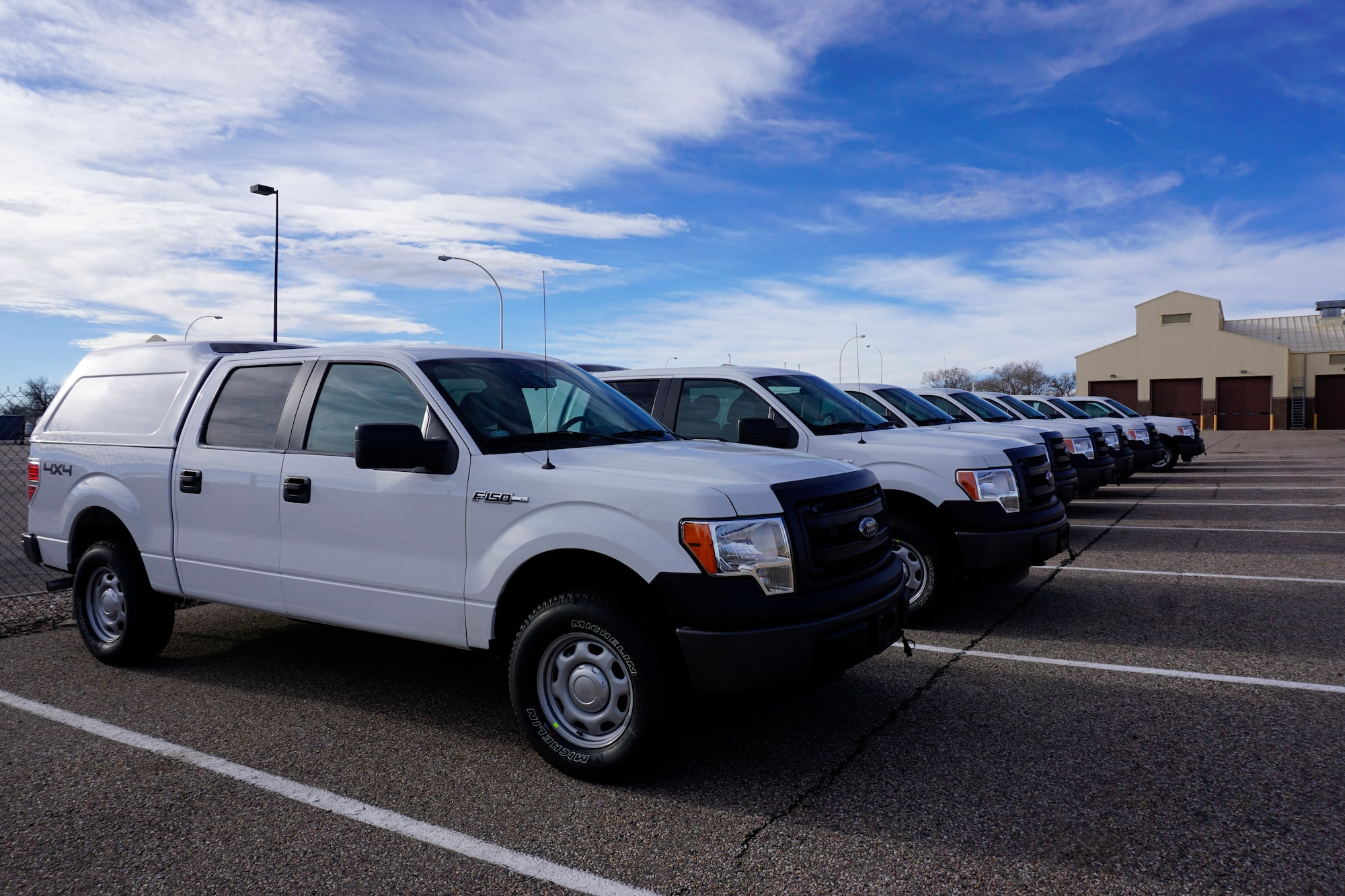 New Ford F-150s sit in the 90th Logistics Readiness Squadron’s parking lot Dec. 12, 2014 on F.E. Warren Air Force Base, Wyo. The trucks are awaiting the final clearance before being added to the distribution lists for travel to the missile field. (U.S. Air Force photo/Lan Kim)