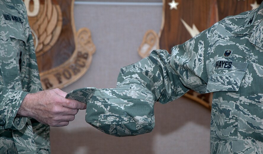 Col. Tracey Hayes, 90th Missile Wing commander, mixes through names in a hat in order to choose the missileers who get to use the new trucks Dec. 5, 2014, as they depart the 90th Operations Group pre-departure room, F.E. Warren Air Force Base, Wyo., and head out to the missile field. The three missile wings under the 20th Air Force each received a set of trucks to help make travel to the missile field safer for the Airmen. (U.S. Air Force photo/Airman 1st Class Brandon Valle)
