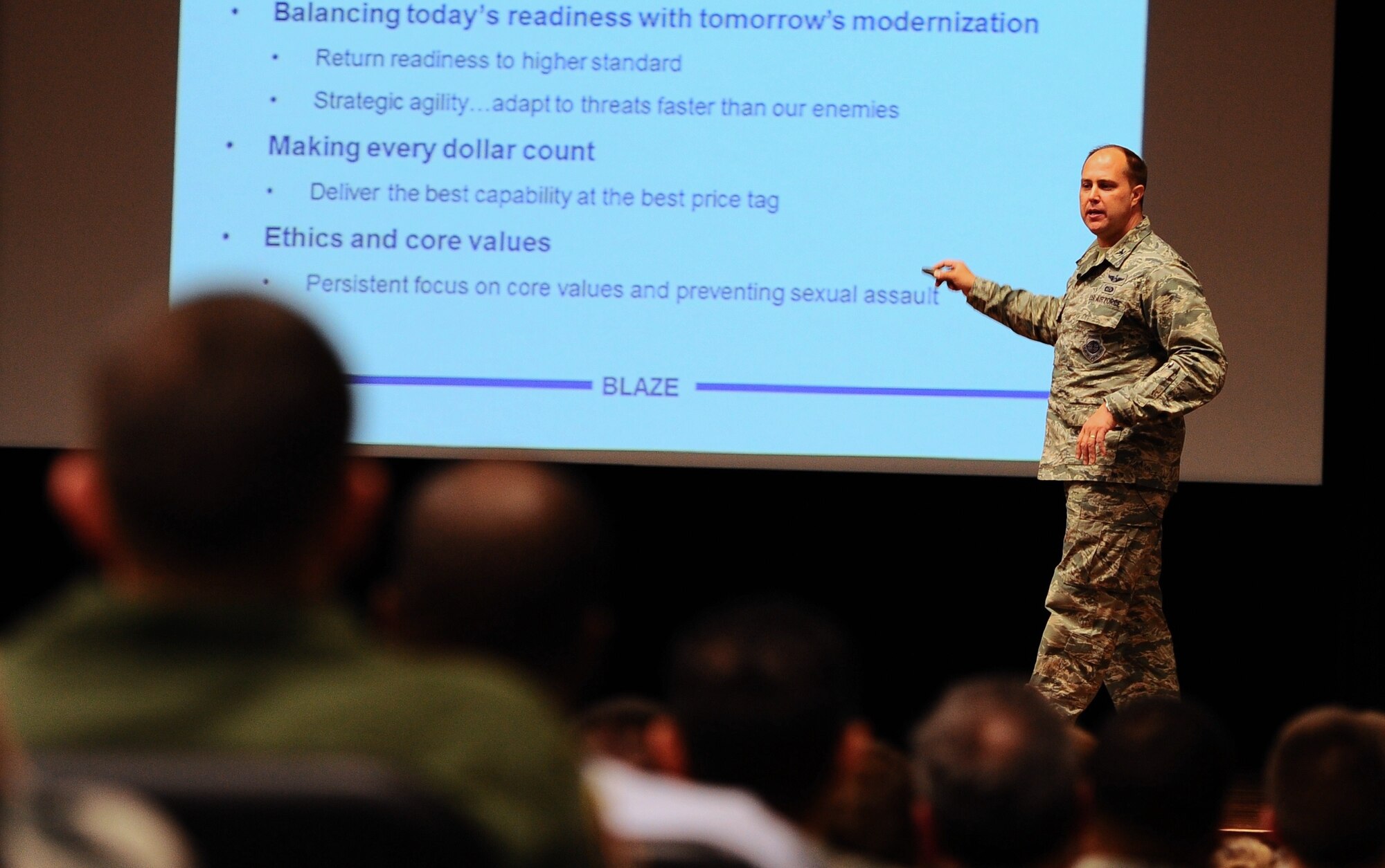 Col. John Nichols, 14th Flying Training Wing Commander, briefs Airmen on Team BLAZE’s goals and values during a commander’s call Dec. 9. During the commander’s calls that day, quality of life and upcoming significant events were discussed. (U.S. Air Force photo/Airman Daniel Lile)