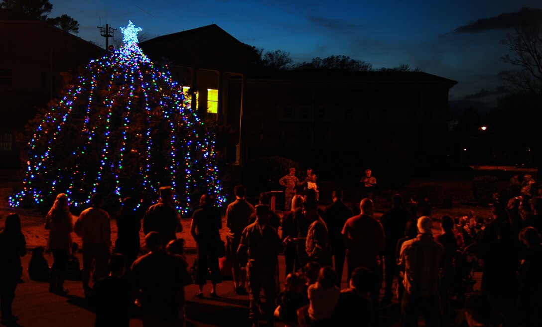 Airmen from Columbus Air Force Base gathered around the front of the Wing Headquarters building to watch the Base Christmas Tree Lighting event Dec. 4. The tree was lit by the family of a deployed Airman from Columbus AFB. Following the tree lighting, Airmen and their families were invited to the Base Chapel where Santa and cookies awaited them. (U.S. Air Force photo/Airman Daniel Lile)