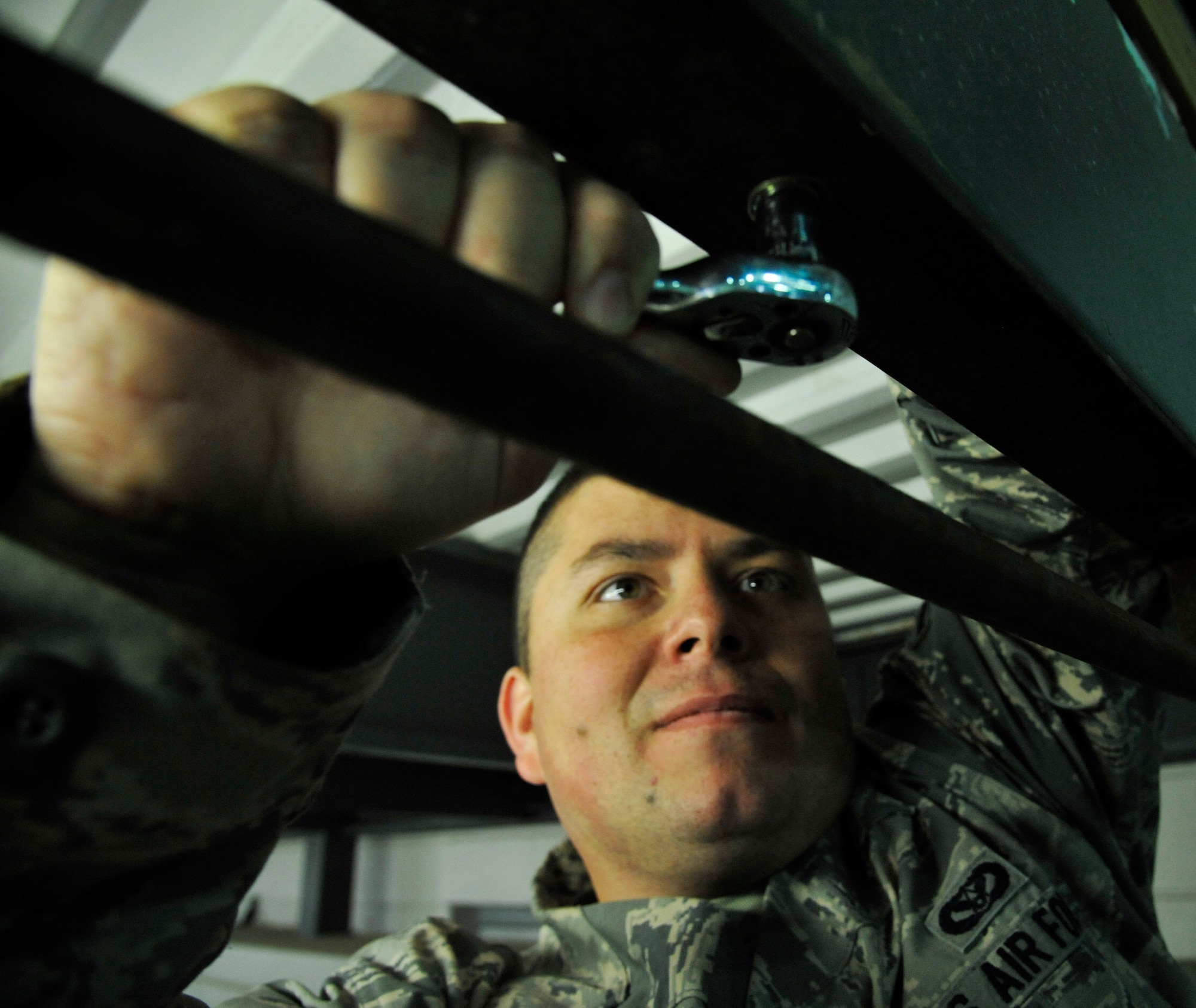 U.S. Air Force Staff Sgt. Cameron Kessinger, 509th Civil Engineer Squadron electrical systems supervisor, secures equipment to existing structure at Whiteman Air Force Base, Mo., Nov. 24, 2014. The direct support the electrical shop provides requires the team to pay close attention to detail and provide quality work. (U.S. Air Force photo by Airman 1st Class Keenan Berry/Released)