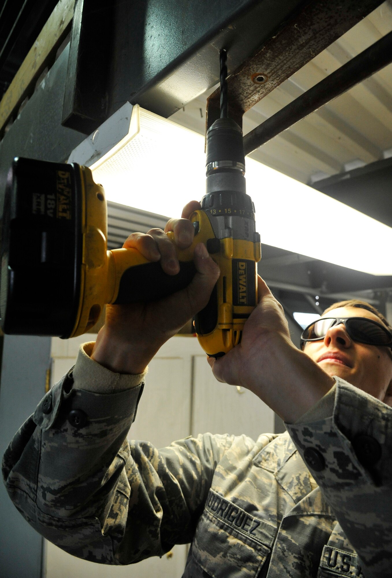 U.S. Air Force Airman 1st Class Robert Rodriguez, 509th Civil Engineer Squadron electrical systems apprentice, mounts pipe to existing structure at Whiteman Air Force Base, Mo., Nov. 24, 2014. This procedure is done to create a securing point for the pipe. (U.S. Air Force photo by Airman 1st Class Keenan Berry/Released)