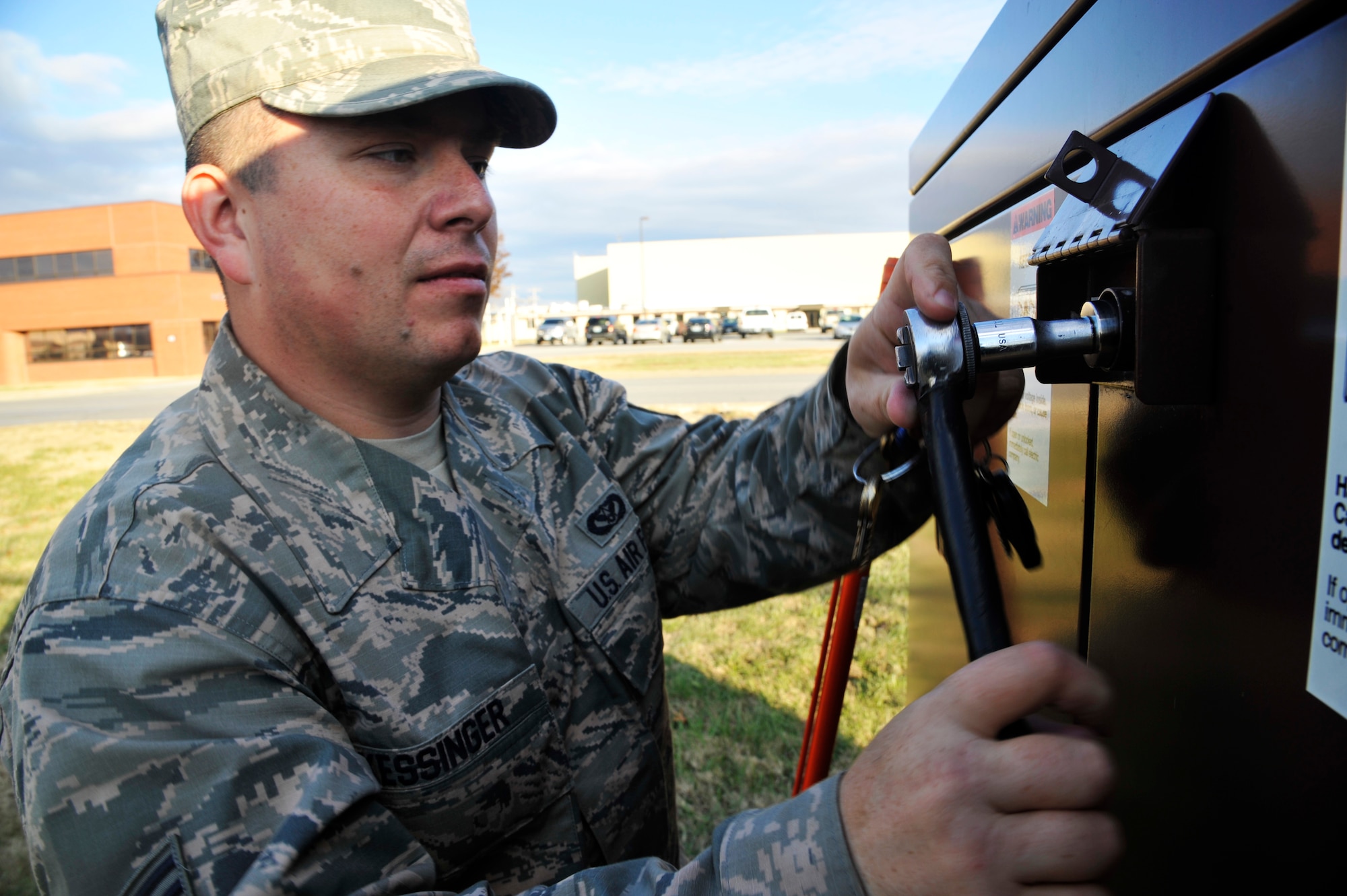 U.S. Air Force Staff Sgt. Cameron Kessinger, 509th Civil Engineer Squadron electrical systems supervisor, opens a high voltage switch at Whiteman Air Force Base, Mo., Nov. 24, 2014. This process is done to verify if the switch’s configuration is in an opened or closed position. (U.S. Air Force photo by Airman 1st Class Keenan Berry/Released)