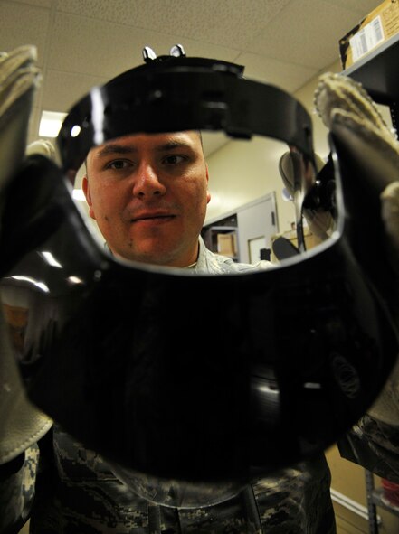 U.S. Air Force Staff Sgt. Cameron Kessinger, 509th Civil Engineer Squadron electrical systems supervisor, inspects a face shield at Whiteman Air Force Base, Mo., Nov. 24, 2014. The electrical shop maintains the flow of electricity for each facility at Whiteman. (U.S. Air Force photo by Airman 1st Class Keenan Berry/Released)