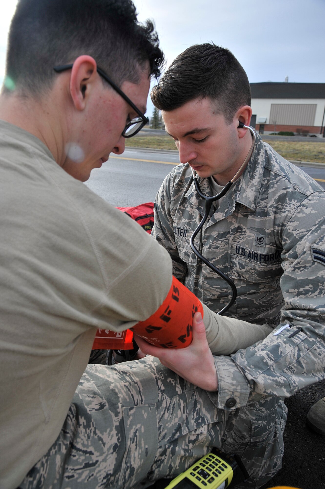 Airman 1st Class Eric Hulten, 92nd Medical Operations Squadron medical technician, checks vital signs of a 92nd Civil Engineer Squadron firefighter during a training exercise Dec. 10, 2014, at Fairchild Air Force Base, Wash. This exercise included hazardous material response teams from both Fairchild and the Spokane, Wash. community to better prepare for real-world situations. (U.S. Air Force photo/Senior Airman Mary O'Dell)