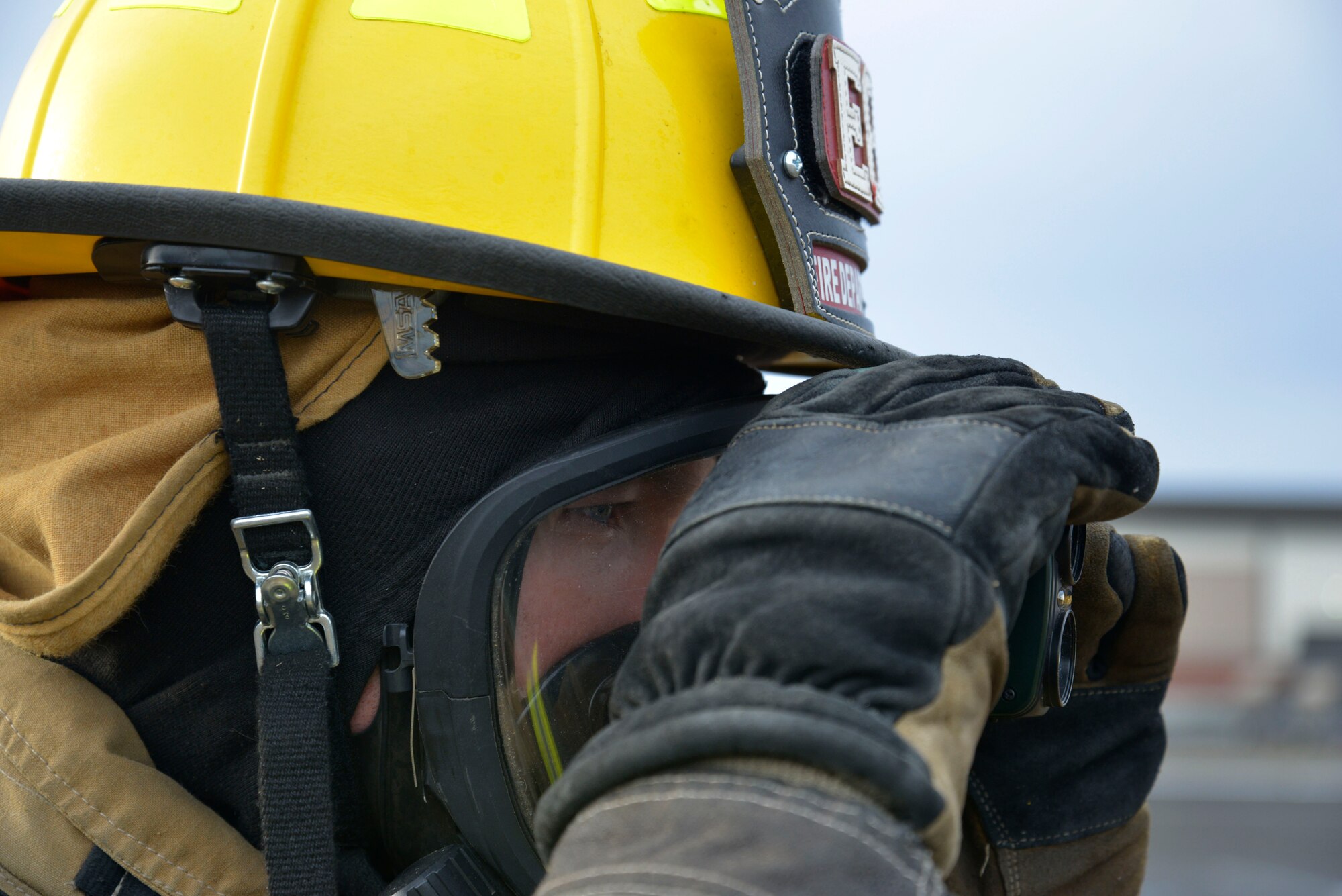 A Fairchild firefighter assesses the scene during a hazardous materials emergency response exercise Dec. 10, 2014 at Fairchild Air Force Base, Wash. During the exercise Fairchild Airmen worked with Local Spokane agencies to practice joint response efforts to prepare for future incidents. (U.S. Air Force photo/Senior Airman Janelle Patiño)