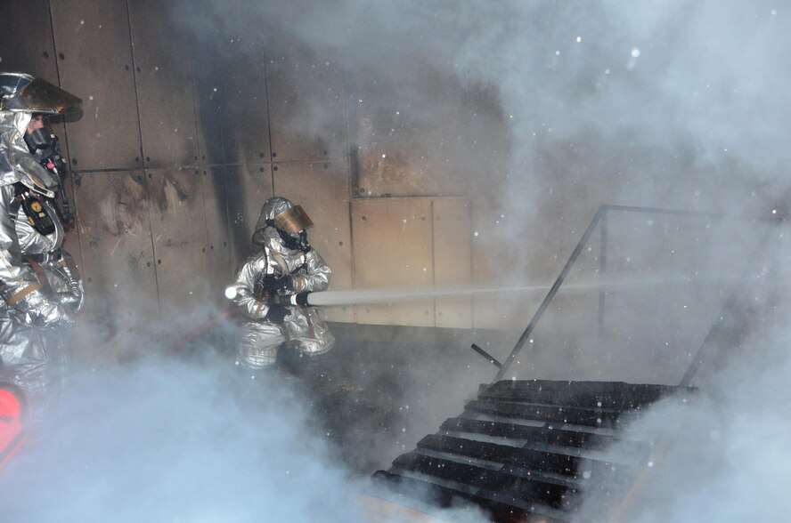 Air Force Reserve firefighters with the 403rd Civil Engineering Squadron, Keesler Air Force Base, Mississippi, douse a fire during an annual structural fire exercise at the Gulfport International Airport Dec. 7, 2014 during the 403rd Wing Unit Training Assembly. (U.S. Air Force photo/Master Sgt. Brian Lamar)