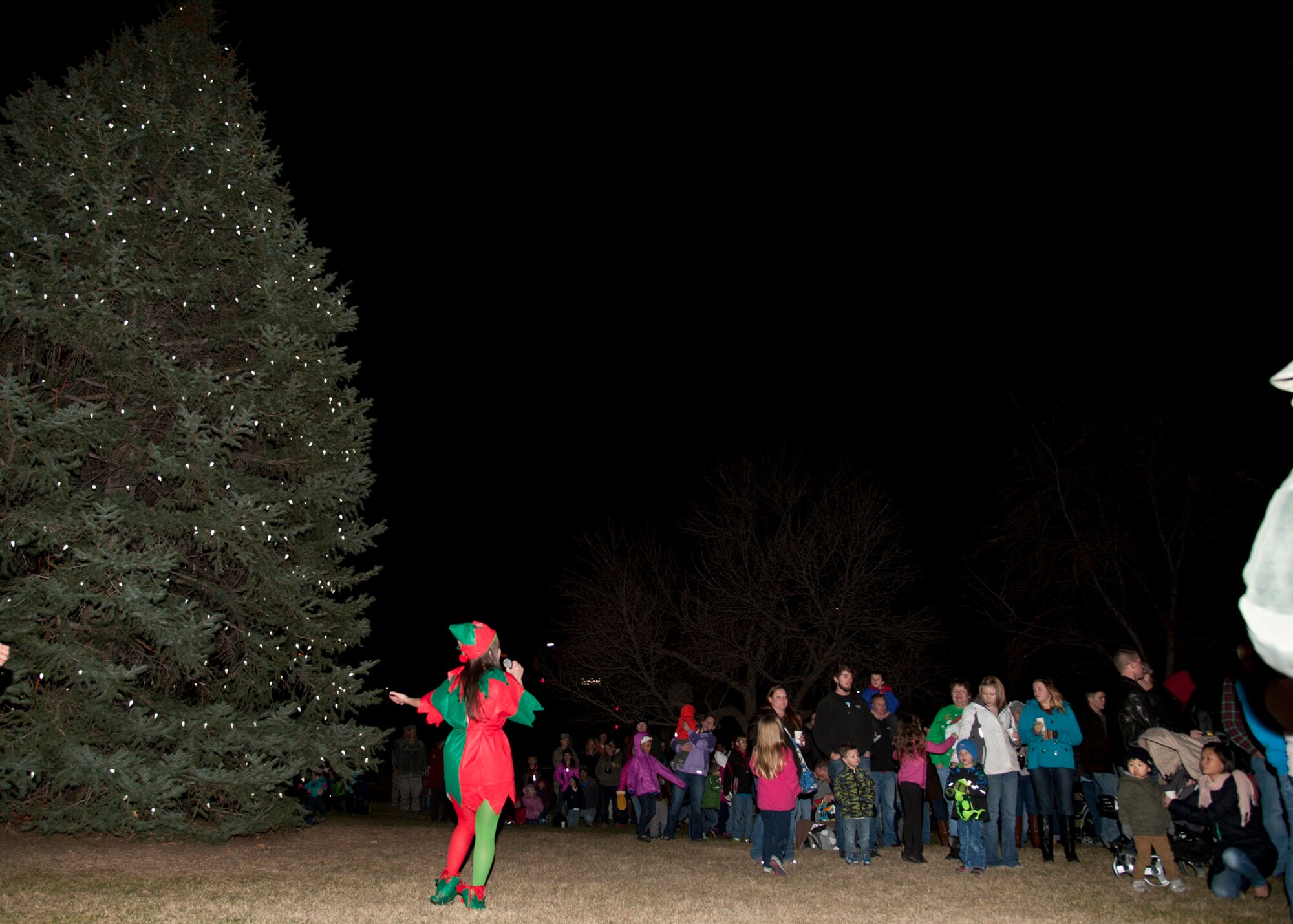 PETERSON AIR FORCE BASE, Colo. – 1st Lt. Nicole Gilmore greets Team Pete families attend the annual Christmas tree lighting at the base Chapel, Dec. 5. This year’s Christmas tree lighting was a family program where children lit a huge Christmas tree, made crafts, played games, iced cookies, met Santa Claus and received a toy. (U.S. Air Force photo by Senior Airman Tiffany DeNault)