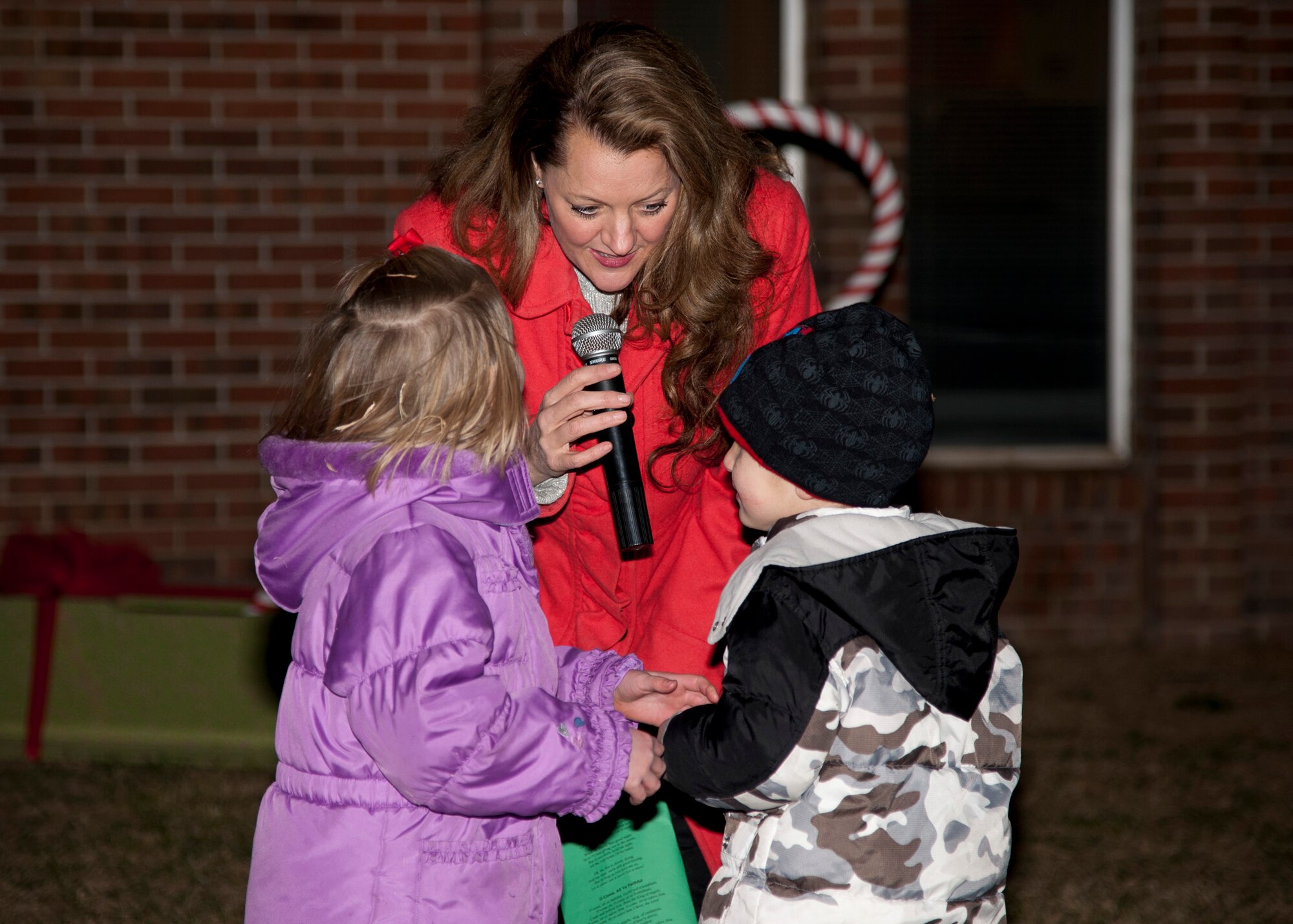 PETERSON AIR FORCE BASE, Colo. – Tech. Sgt. Julie Bradley, a vocalist with the U.S. Air Force Academy Band’s Blue Steel ensemble, sings a Christmas song during the Christmas tree lighting at the base Chapel, Dec. 5. This year’s Christmas tree lighting was a family program where children lit a huge Christmas tree, made crafts, played games, iced cookies, met Santa Claus and received a toy (U.S. Air Force photo by Senior Airman Tiffany DeNault)