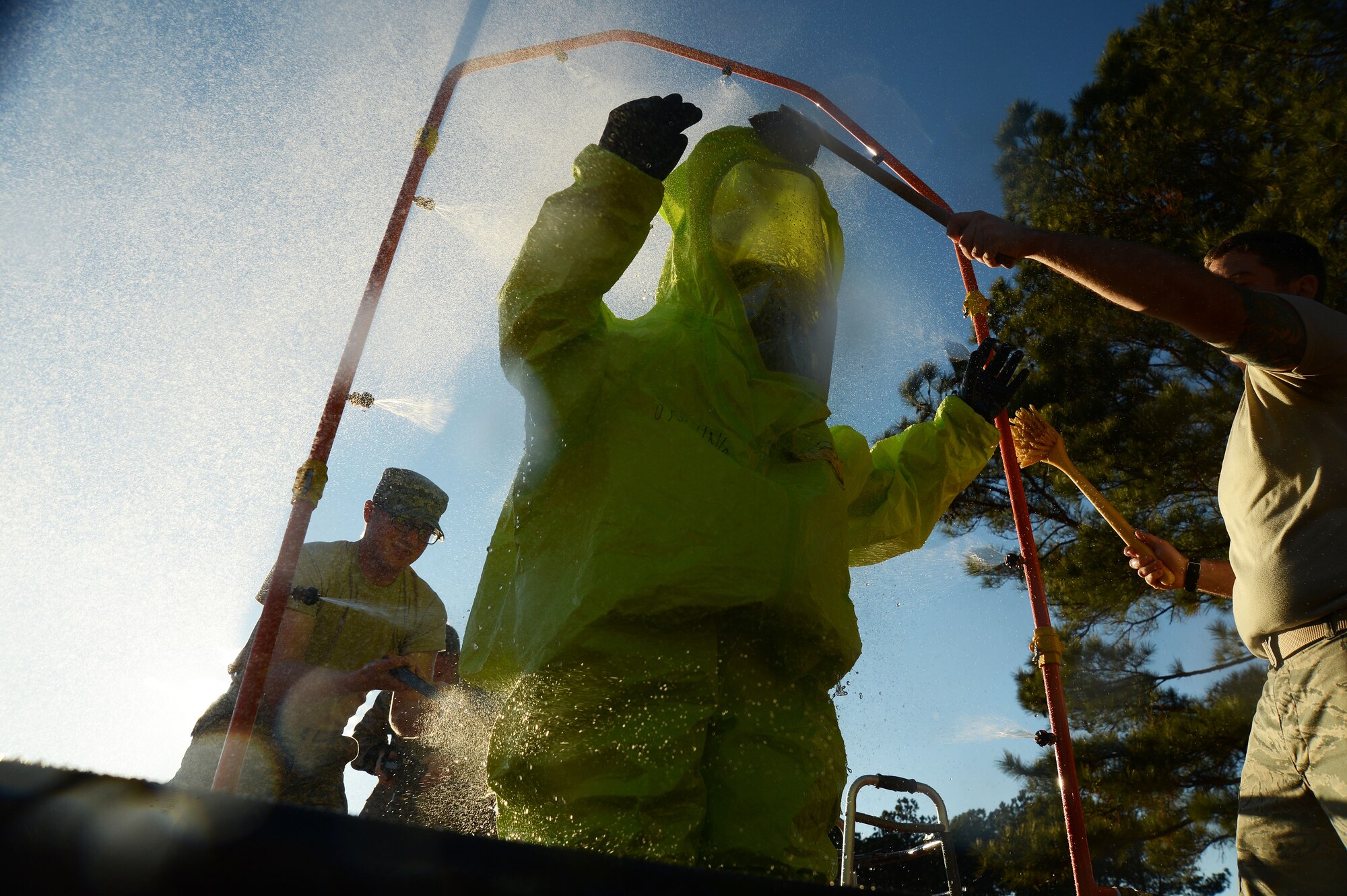 A U.S. Air Force Airman is washed in a decontamination shower during an integrated base emergency response capability training exercise at Shaw Air Force Base, S.C., Dec. 10, 2014. The exercise was a week long training session that consisted of both academic learning and hands-on training. (U.S. Air Force photo by Airman 1st Class Michael Cossaboom/Released)