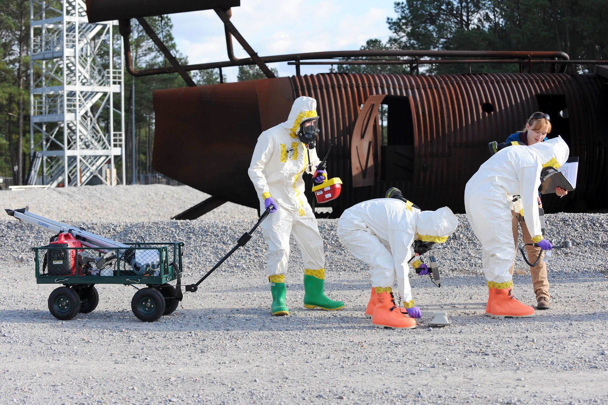 (From left) U.S. Air Force Senior Airmen Chantal Hogue and Lauren Yancey, 20th Civil Engineer Squadron emergency management apprentices, and Senior Airman Jordan Gagne, 20th Aerospace Medicine Squadron bioenvironmental engineering journeyman, participate in an integrated base emergency response capability training at Shaw Air Force Base, S.C., Dec. 9, 2014. During the exercise, the Airmen acted as the initial entry team in response to a simulated chemical attack. (U.S. Air Force photo by Airman 1st Class Michael Cossaboom/Released)