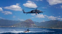 Senior Master Sgt. Roger Sparks, 212th Rescue Squadron pararescueman, hoists up simulated survivors into an HH-60 Pave Hawk about five miles off of the coast of Oahu Feb. 12th, during Lava Rescue 2014. Training exercises included search and rescue operations performed at sea during the day, and additional search and rescue training after dark with night-vision equipment.