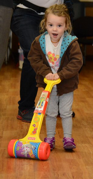 A child uses her newly acquired toy Dec. 5 at Travis Air Force Base. She picked her new toy from the collection of 10,000 donated toys during Operation Homefront. (U.S. Air Force photo by Airman 1st Class Amber Carter)