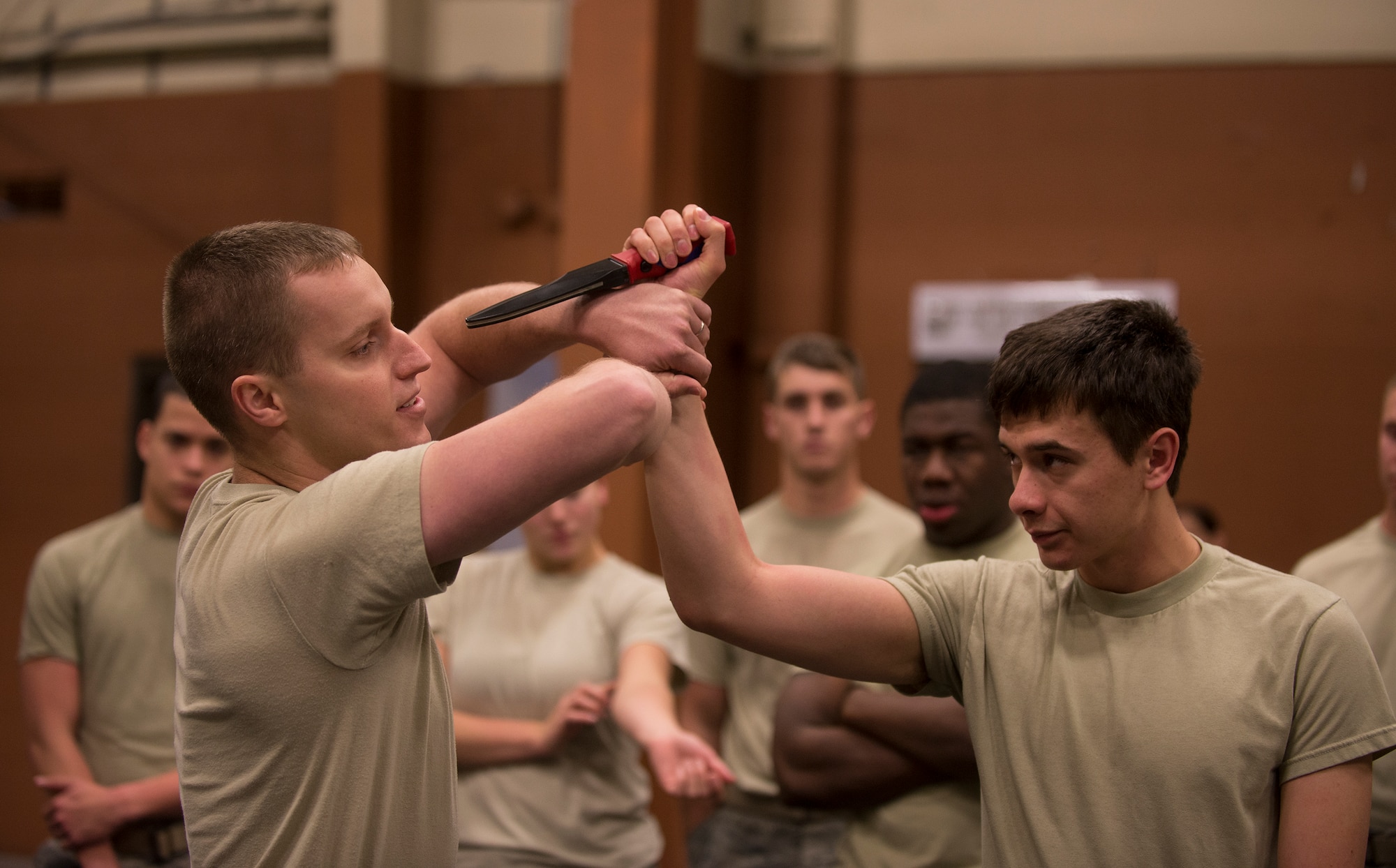 U.S. Air Force Tech. Sgt. Paul Kalle, left, 823d Base Defense Squadron fireteam leader, teaches Airmen how to defend themselves from a knife attack as part of security forces combatives training Dec. 9, 2014, at Moody Air Force Base, Ga. The group practiced techniques to avoid knife thrusts and slashes. (U.S. Air Force photo by Senior Airman Sandra Marrero/Released)
