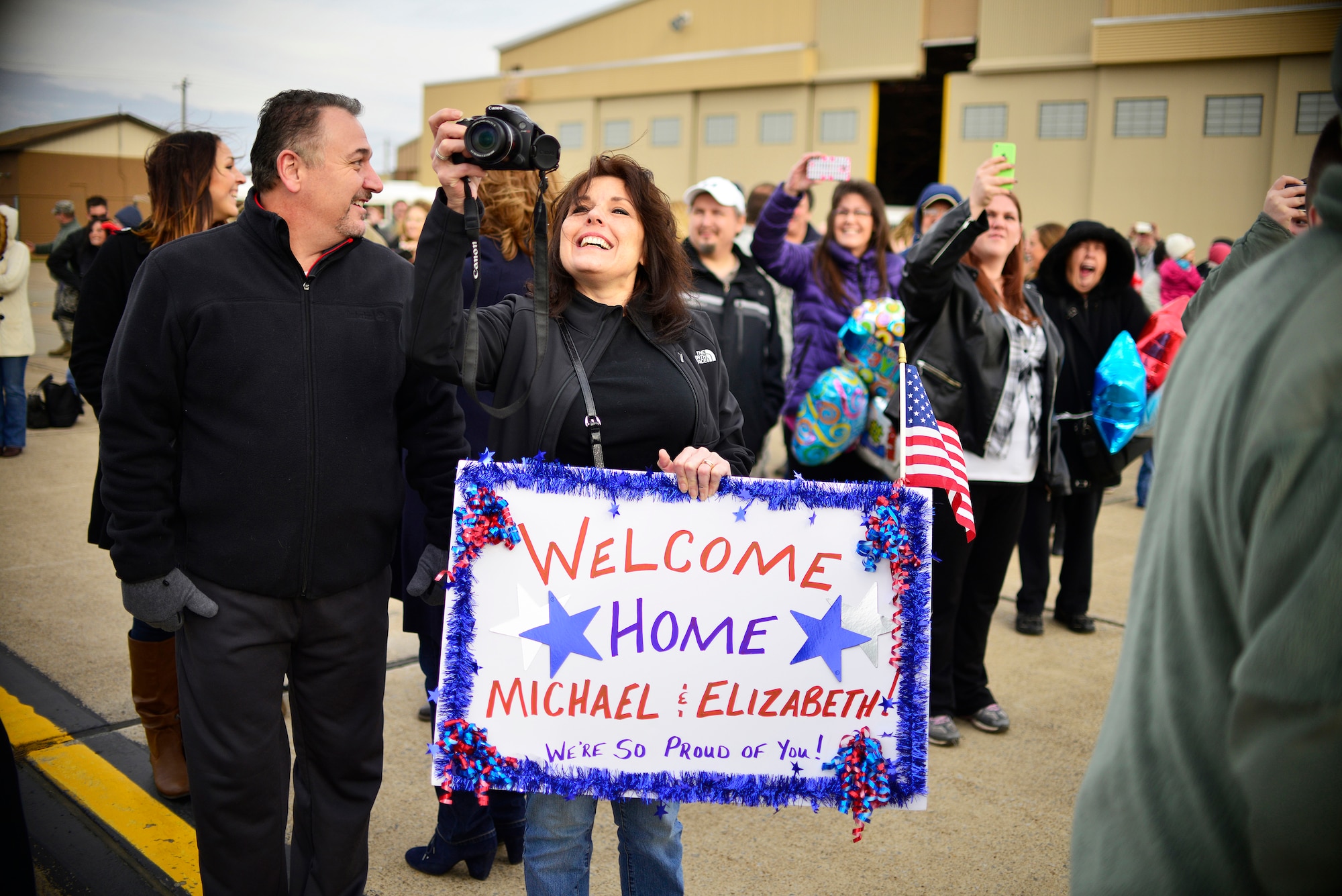 Family members of the 30th Aerial Port Squadron wait for the unit to return home Dec. 6, 2014 at Niagara Falls Air Reserve Station, N.Y. 35 personnel from the base were sent to a deployment in Afghanistan. (U.S. Air Force Photo by Staff Sgt. Stephanie Sawyer)