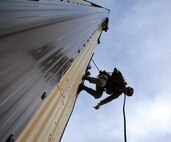 Members from the 341st Security Forces Group Tactical Response Force rappel during a training exercise Dec. 10 at Malmstrom Air Force Base. TRF members begin their training as assaulters and go on to acquire one of two additional skill sets in the fields of breaching systems or nuclear advanced designated marksmen, commonly referred to as snipers. (U.S. Air Force photo/ 2nd Lt. Annabel Monroe)  
