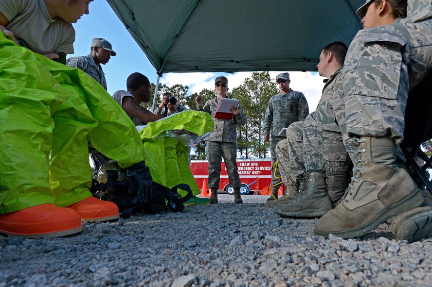 U.S. Air Force Airmen assigned to the 20th Civil Engineer Squadron, are briefed on a simulated hazardous scenario during an integrated base emergency response capability training exercise at Shaw Air Force Base, S.C., Dec. 10, 2014.  During the five-day training, Airmen were tested on their emergency response preparedness through a series of simulated chemical and biological attacks. (U.S. Air Force photo by Airman 1st Class Jensen Stidham/Released)