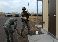 Members from the 341st Security Forces Group Tactical Response Force rappel during a training exercise Dec. 10 at Malmstrom Air Force Base. TRF members begin their training as assaulters and go on to acquire one of two additional skill sets in the fields of breaching systems or nuclear advanced designated marksmen, commonly referred to as snipers. (U.S. Air Force photo/ 2nd Lt. Annabel Monroe)  