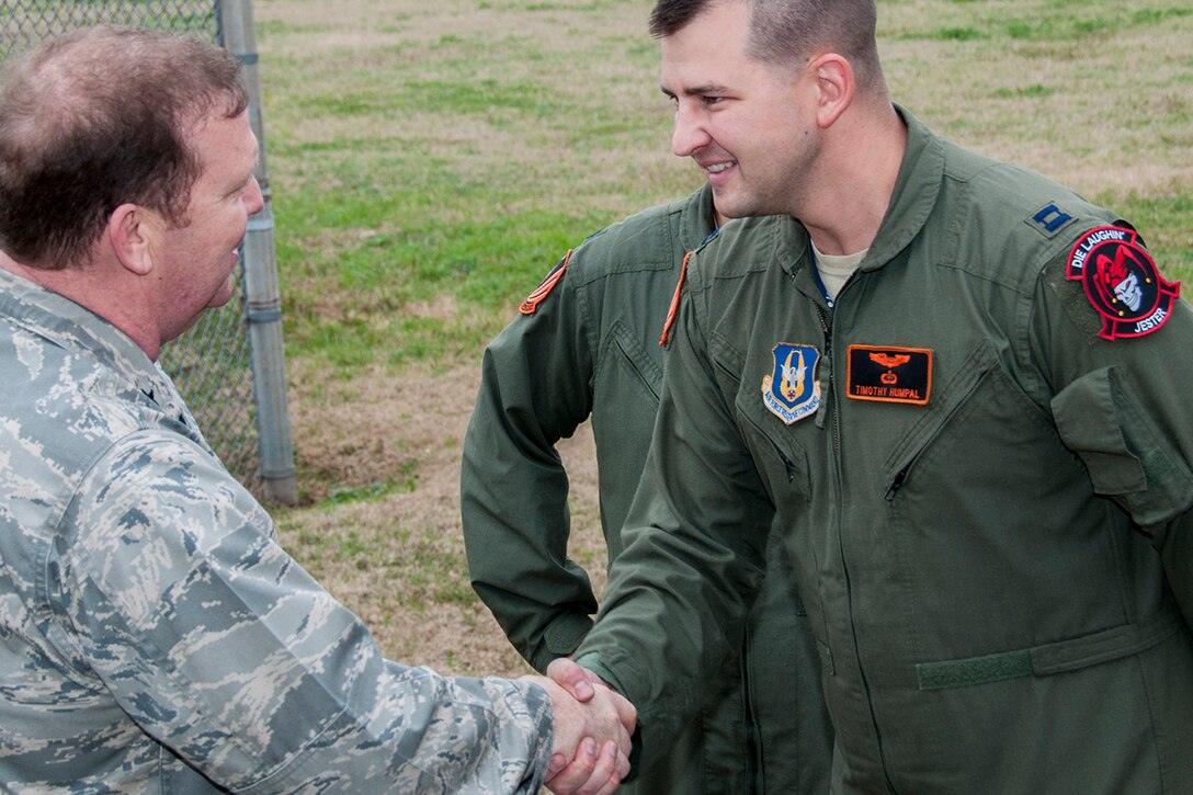 U.S. Air Force Brig. Gen. Richard Scobee, 10th Air Force commander, congratulates U.S. Air Force Capt. Timothy Humpal, 343rd Bomb Squadron B-52 radar navigator, on his squadron’s win of the Mitchell Trophy, Dec. 6, 2014, Barksdale Air Force Base, La. The trophy was awarded to the squadron for hitting closest to the target during the bombing competition of the Air Force Global Strike Challenge. (U.S. Air Force photo by Tech. Sgt. Ted Daigle/Released)