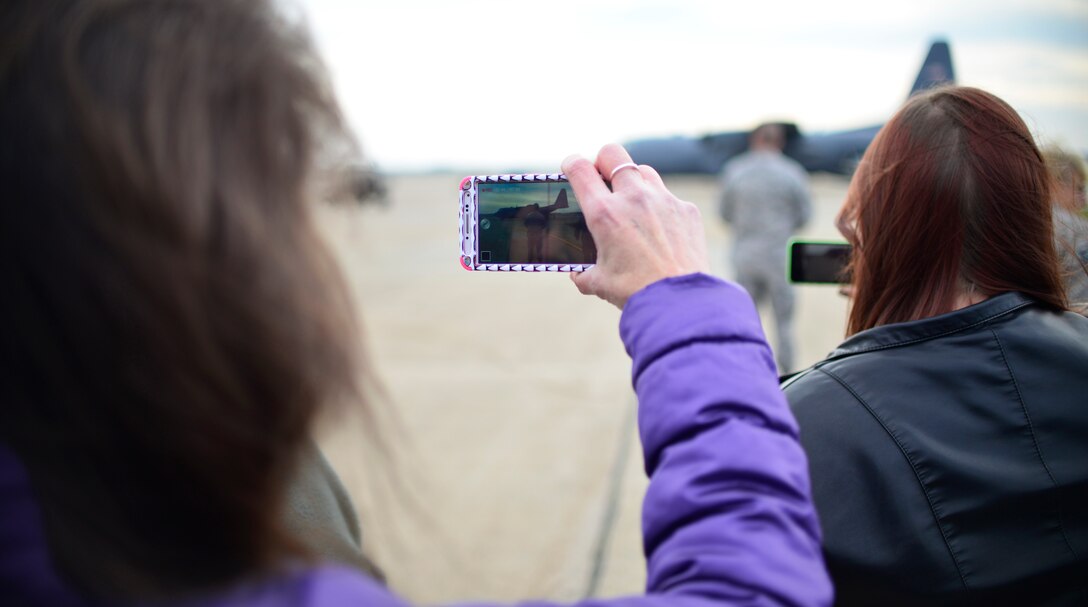 Family members of the 30th Aerial Port Squadron wait for the unit to return home Dec. 6, 2014 at Niagara Falls Air Reserve Station, N.Y. 35 personnel from the base were sent to a deployment in Afghanistan. (U.S. Air Force Photo by Staff Sgt. Stephanie Sawyer) 