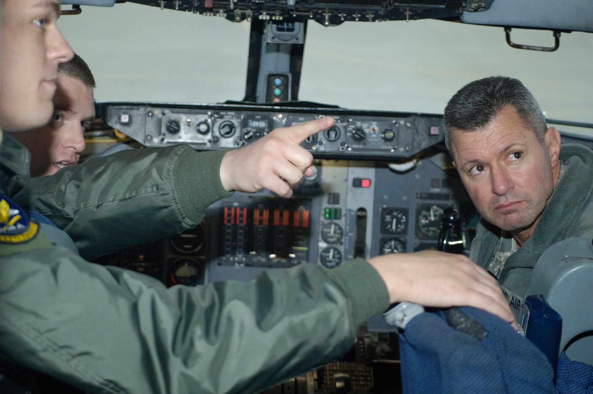 Lt. Gen. Greg Biscone, Air Force Inspector General, right, sits in the cockpit of an E-3 “Sentry” Airborne Warning and Control System aircraft and discusses the Block 40/45 upgrade with Capt. Grant Milbourn, pointing, and Staff Sgt. Zachary Kruly of the 965th Airborne Air Control Squadron during his tour of Tinker Air Force Base, Dec. 2-5. During his visit, General Biscone toured the High Frequency Program Office, Office of Special Investigations, Oklahoma City Air Logistics Complex, 507th Air Refueling Wing and 552nd Air Control Wing. During his stay, the general also attended a number of meetings and briefings, including him briefing Tinker’s senior leaders on the Air Force’s new inspection system. Captain Milbourn is the squadron deputy flight safety officer and a co-pilot on the E-3, while Sergeant Kruly is the squadron safety noncommissioned officer-in-charge and a flight engineer. (Air Force photo by Darren D. Heusel)