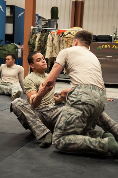 U.S. Air Force Senior Airman Patrick Dugan, 823d Base Defense Squadron fireteam leader, gets in a defensive position during security forces combatives training Dec. 9, 2014, at Moody Air Force Base, Ga. The move is known as pulling guard. (U.S. Air Force photo by Senior Airman Sandra Marrero/Released)
