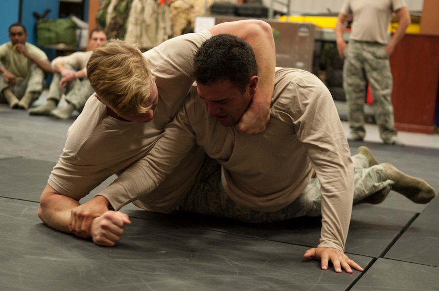 U.S. Air Force Senior Airman Christopher Stewart, left, and Airman Steven Carcamo, 823d Base Defense Squadron fireteam members, grapple during security forces combatives training Dec. 9, 2014, at Moody Air Force Base, Ga. The 823d BDS spent one day of training learning self-defense and the next putting them into practice. (U.S. Air Force photo by Senior Airman Sandra Marrero/Released)
