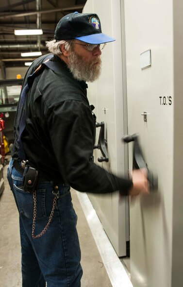 Gary Kaylor, 5th Logistics Readiness Squadron superintendent of general purpose allied trade, looks through technical orders in the 5th LRS maintenance bay on Minot Air Force Base, N.D., Dec. 2, 2014. Many TOs have already been transferred to a digital medium and soon hardcopies will be a thing of the past. (U.S. Air Force photo/Senior Airman Stephanie Morris)