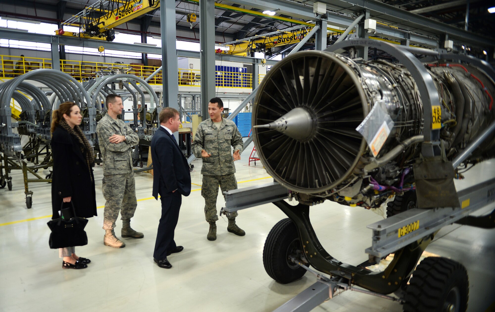 Senior Airman Patric Naranjo, 48th Component Maintenance Squadron aerospace propulsion journeyman, briefs the Right Honourable Mark Francois, Minister of State for the Armed Forces, during a tour of the 48th Fighter Wing at Royal Air Force Lakenheath, England, Dec. 11, 2014. Inviting key members from the local community, such as Francois, helps elevate community relations and increase understanding of the 48th FW’s mission to provide worldwide response combat airpower and support to meet our nation’s objectives. (U.S. Air Force photos by Staff Sgt. Emerson Nuñez/Released)