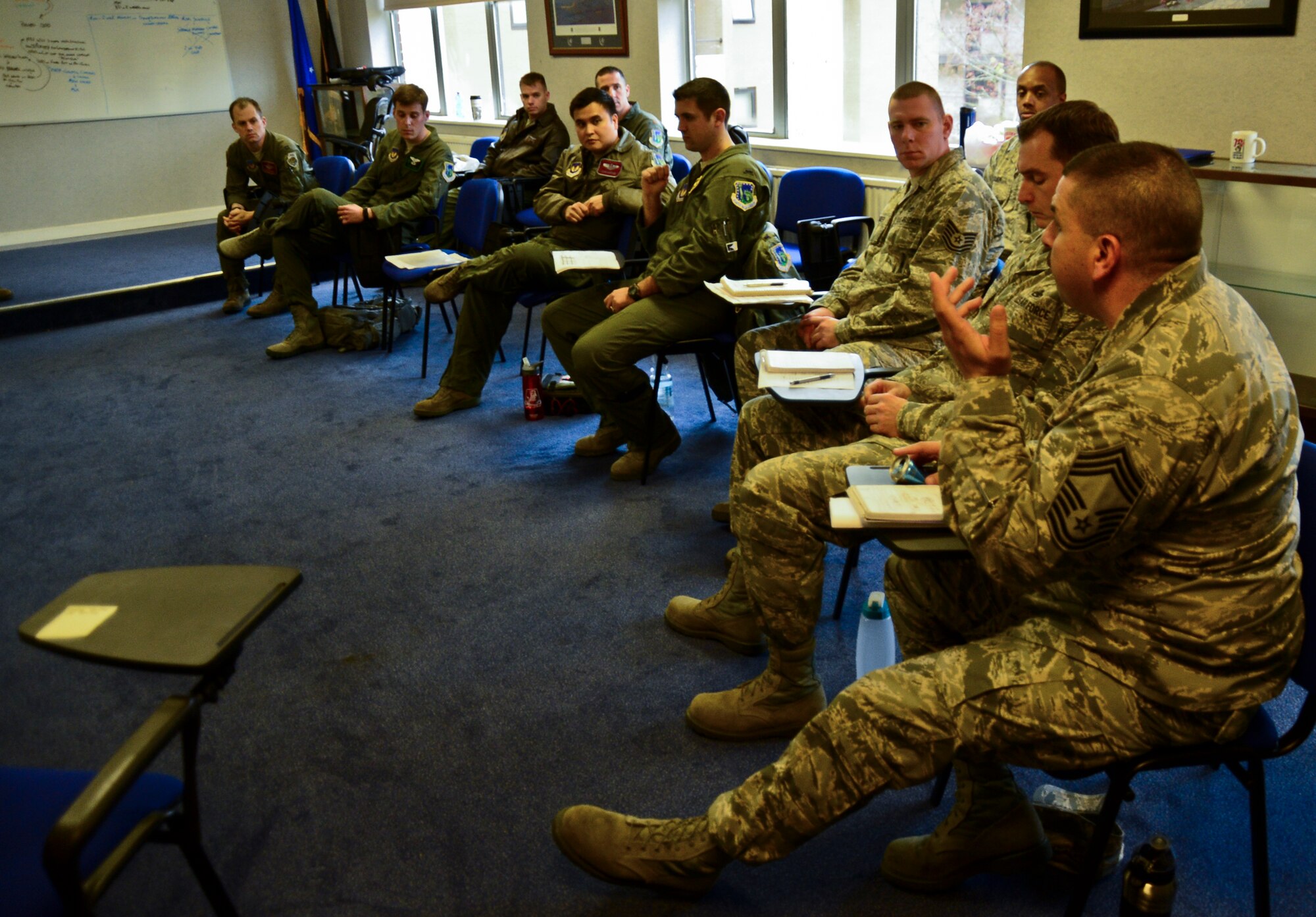 Liberty Airmen participating in an Air Force Smart Operations for the 21st Century event discuss ways to improve the scheduling process for the 48th Munitions Squadron at Royal Air Force Lakenheath, England, Nov. 18, 2014. The team identified that the original scheduling process had not taken into consideration the work schedule for the 48th Munitions Squadron, which resulted in instability in the shop and unscheduled work orders.  (U.S. Air Force photo by Airman 1st Class Erin R. Babis/ Released) 