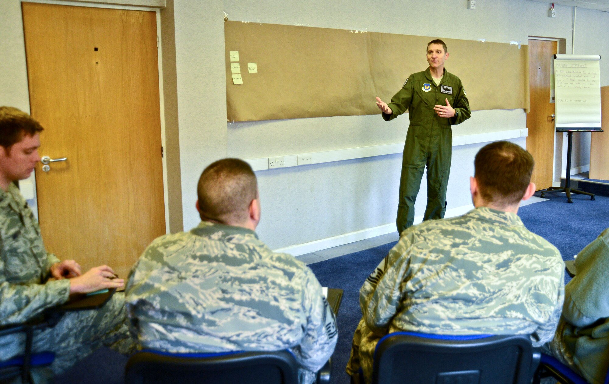 Col. Scottie Zamzow, 48th Operations Group commander, briefs participants of an Air Force Smart Operations for the 21st Century event at Royal Air Force Lakenheath, England, Nov. 18, 2014. The goal of the AFSO21 event was to reduce the amount of unscheduled work for the 48th Munitions squadron, to maximize efficiency and make every dollar count. (U.S. Air Force photo by Airman 1st Class Erin R. Babis/ Released) 