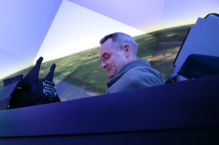 U.S. Air Force Lt. Gen. Darryl Roberson, 3rd Air Force and 17th Expeditionary Air Force commander, operates an F-16 Fighting Falcon fighter aircraft flight simulator during an immersion visit Dec. 9, 2014, to Spangdahlem Air Base, Germany. Roberson, a previous wing commander at Spangdahlem from 2006-2008, toured new the facilities that were not here during his command. (U.S. Air Force photo by Airman 1st Class Dylan Nuckolls/Released)