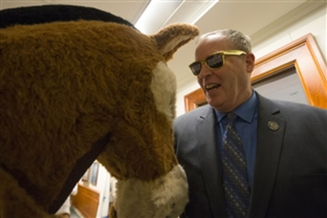 Deputy Defense Secretary Bob Work bonds with the Army's mule mascot during a pep rally for cadets from the U.S. Military Academy at West Point at the Pentagon, Dec. 12, 2014, before the upcoming Army-Navy football game.