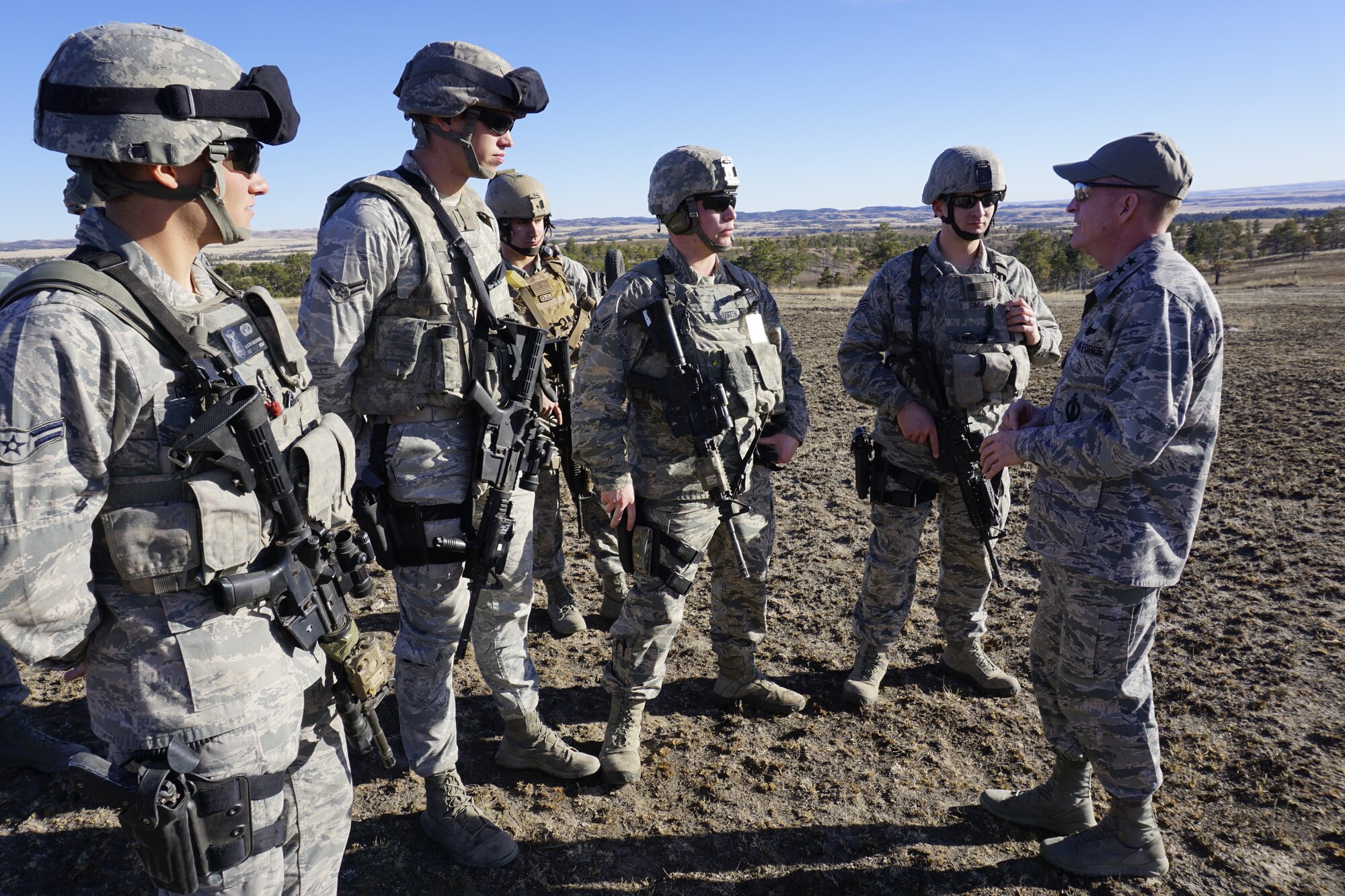 Lt. Gen. Stephen Wilson, Air Force Global Strike Command commander, speaks with 620th Ground Combat Training Squadron trainees on Camp Guernsey, Wyo., Dec. 11, 2014. The trainees completed a course that demonstrated tactics and techniques of explosive breaching of entry points. (U.S. Air Force photo/Lan Kim)