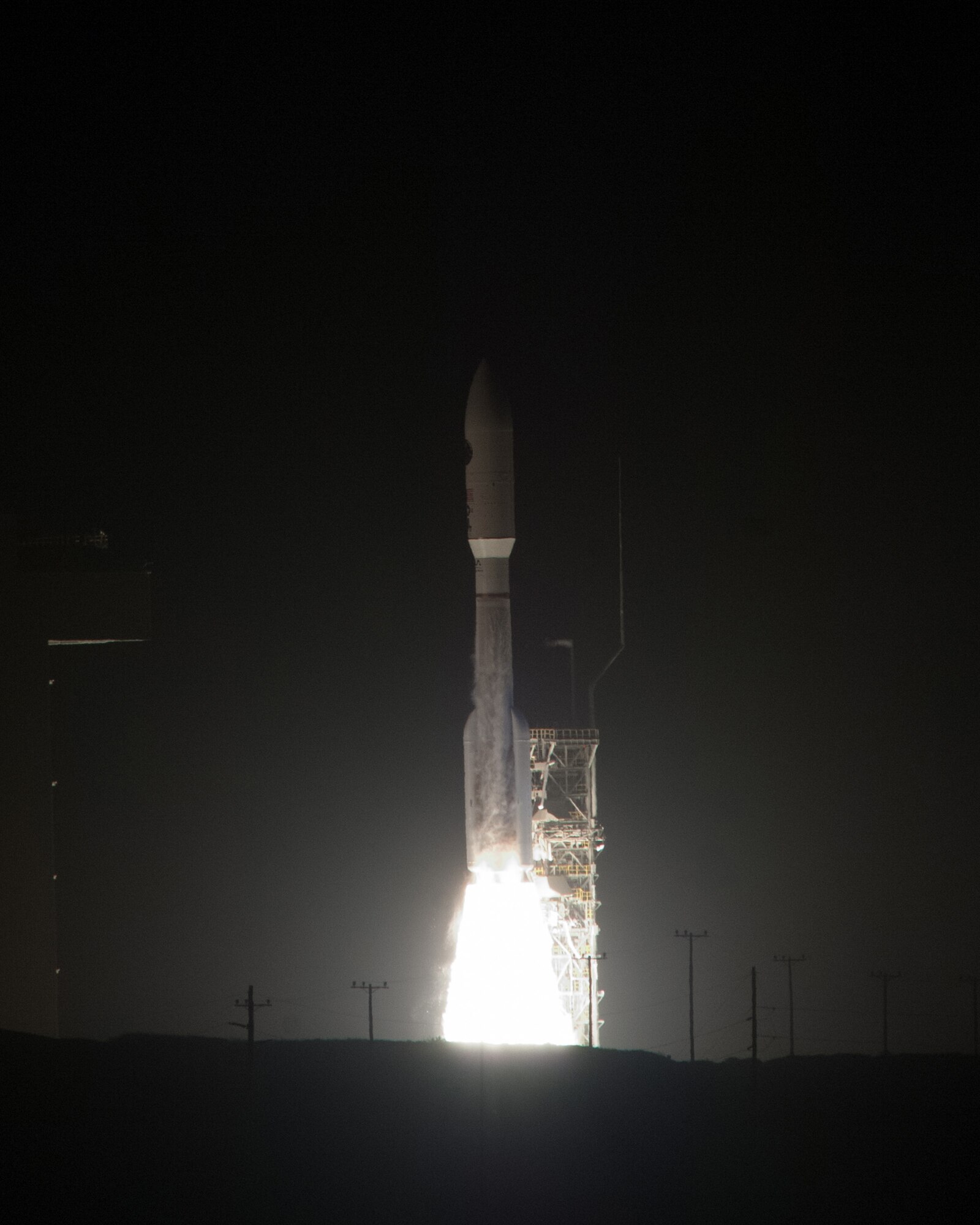 A United Launch Alliance Atlas V rocket carrying a National Reconnaissance Office payload successfully launches from Space Launch Complex-3 at Vandenberg Air Force Base, Calif., Dec. 12, at 7:19 p.m. PDT. This is the most powerful Atlas V rocket launched from Vandenberg because it has four solid rocket boosters, producing approximately 250,000 pounds of thrust per solid rocket. These four solids along with the main engine of the Atlas V produced a total thrust around 2 million pounds at liftoff. (U.S. Air Force photo by Michael Peterson/Released)