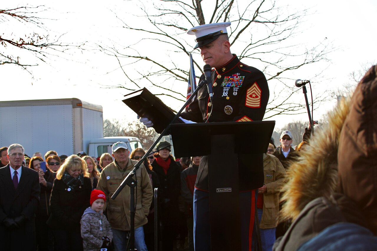 Marine Corps Sgt. Maj. Bryan Battaglia, senior enlisted advisor to the Chairman of the Joint Chiefs of Staff, addresses service members and volunteers during the opening ceremony on Wreaths Across America Day in Arlington National Cemetery, Arlington, Va., Dec. 13, 2014. Battaglia read a letter co-written with Army Gen. Martin E. Dempsey, chairman of the Joint Chiefs of Staff, thanking Wreaths Across America cofounders Morill and Karen Worcester for their support of fallen service members. DOD photo by Sebastian Sciotti Jr.