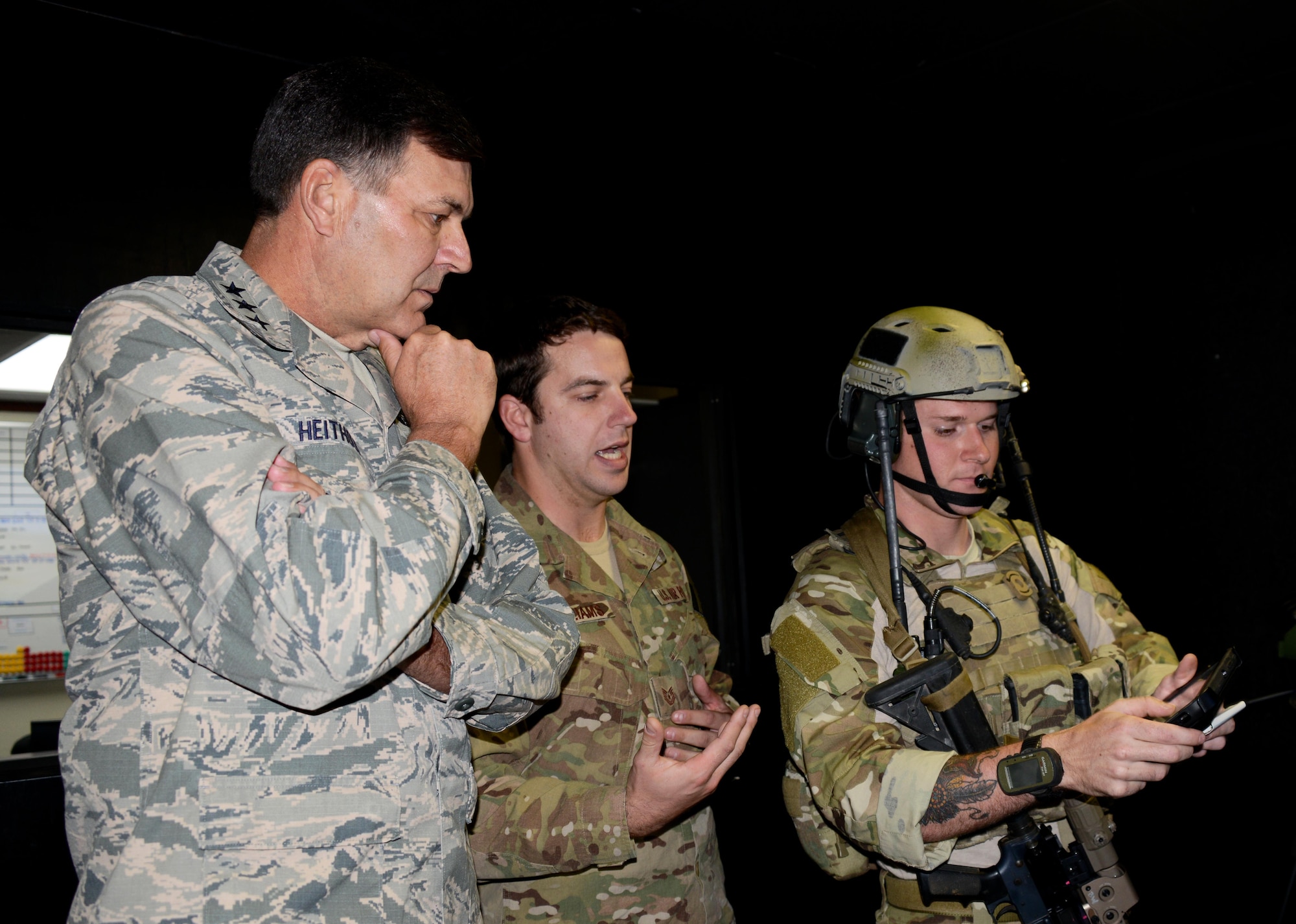 Tech. Sgt. Aaron Williams, center, and Senior Airman Adam Smith, right, combat controllers at the 320th Special Tactics Squadron show Lt. Gen. Bradley Heithold, Air Force Special Operations Command commander, the Joint Terminal Air Controller simulator during a tour of the 320th STS Dec. 5, 2014 at Kadena Air Base, Japan.   AFSOC leadership visited the Airmen of the 353rd Special Operations Group to get a closer look at the special operations mission in the Pacific.  (U.S. Air Force photo by Tech. Sgt. Kristine Dreyer)