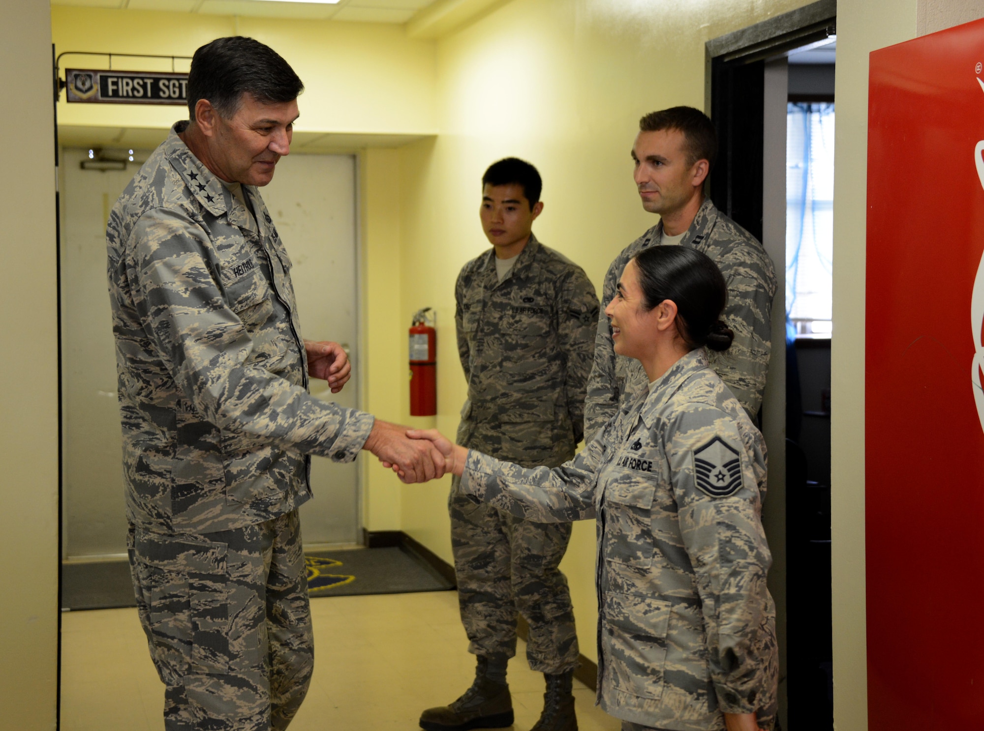 Lt. Gen. Bradley Heithold shakes hands with Master Sgt. Edith Smith, 353rd Special Operations Maintenance Squadron, maintenance operations flight chief, during a visit Dec. 5, 2014 at Kadena Air Base, Japan. AFSOC leadership visited the Airmen of the 353rd Special Operations Group to get a closer look at the special operations mission in the Pacific.  During the visit, the AFSOC commander and command chief visited each squadron in the 353rd SOG and met with Airmen. (U.S. Air Force photo by Tech. Sgt. Kristine Dreyer)