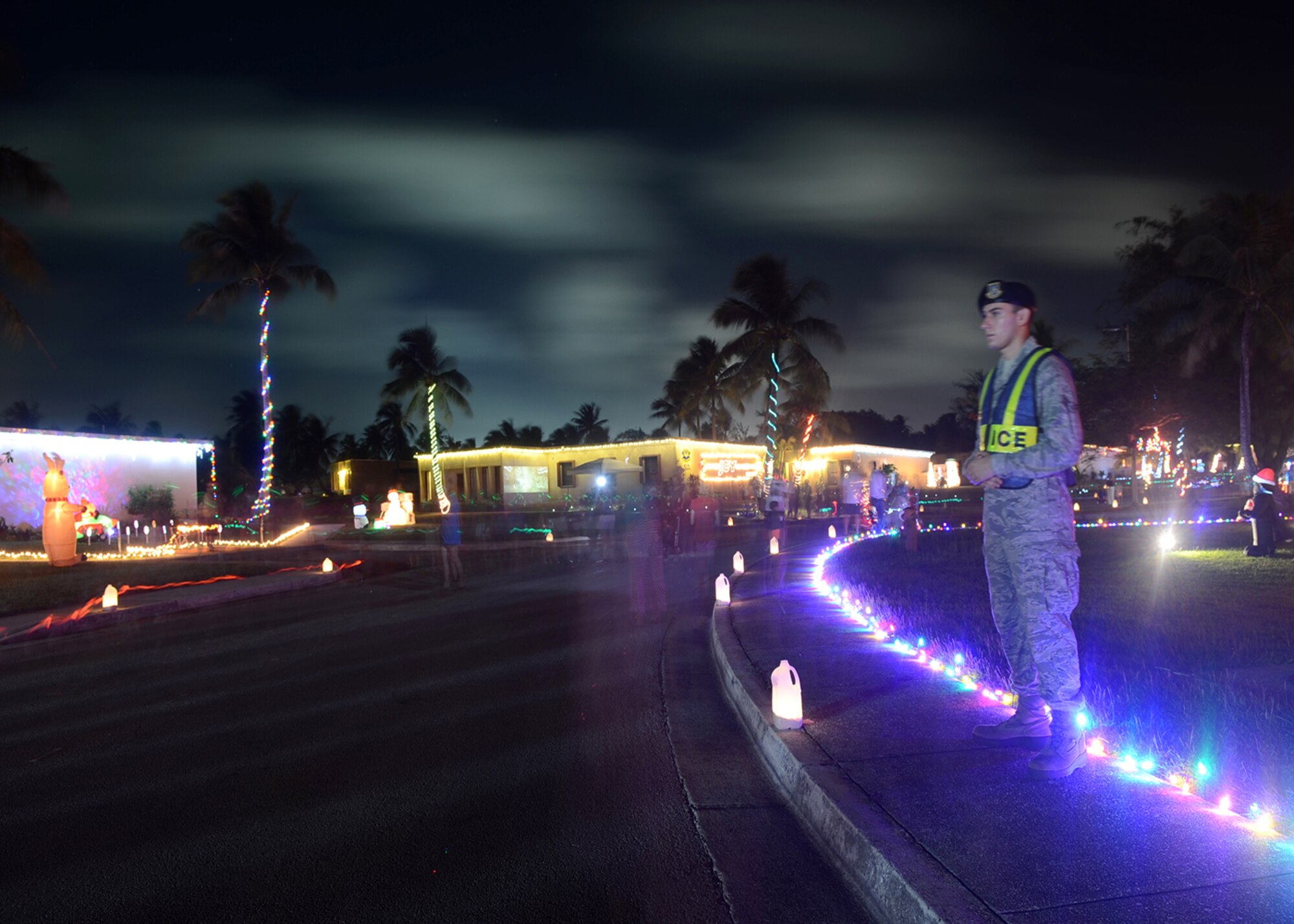 Airman 1st Class Jon Simotas, 36th Security Forces Squadron, helps ensure the safety of several hundred pedestrians participating in the annual Rota Walk Dec. 13, 2014, at Andersen Air Force Base, Guam. More than 300 military members and civilians attended the event which is held every December. (U.S. Air Force photo by Tech. Sgt. Zachary Wilson/Released)
