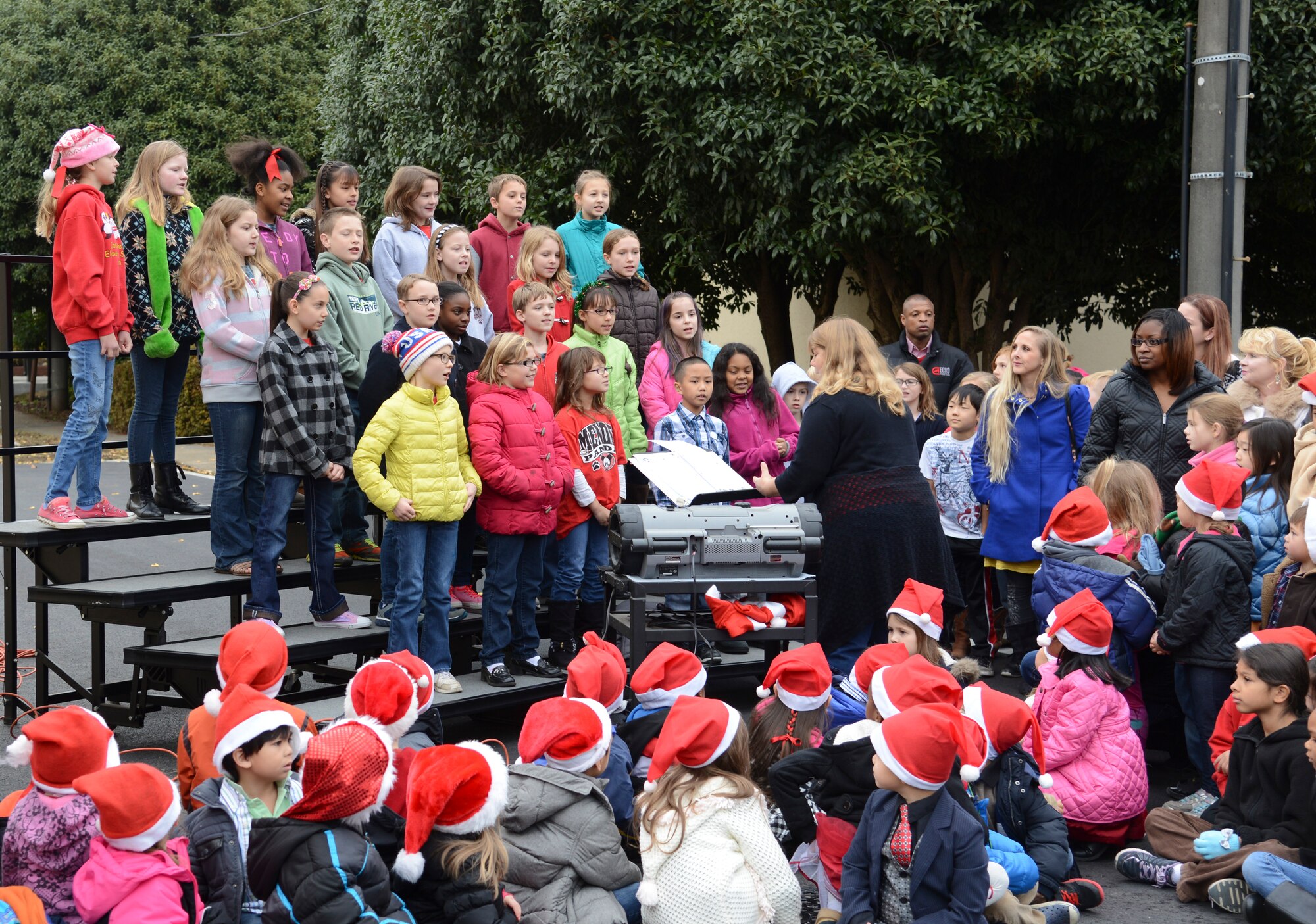 Members of the Joan K. Mendel Elementary School chorus sing Holiday songs during the ribbon cutting for a new Kindergarten building at Yokota Air Force Base, Japan, Dec. 12, 2014. The new building is the first 21st Century building in the Department of Defense Education Activity Pacific.  (U.S. Air Force photo by Senior Airman Michael Washburn/Released)