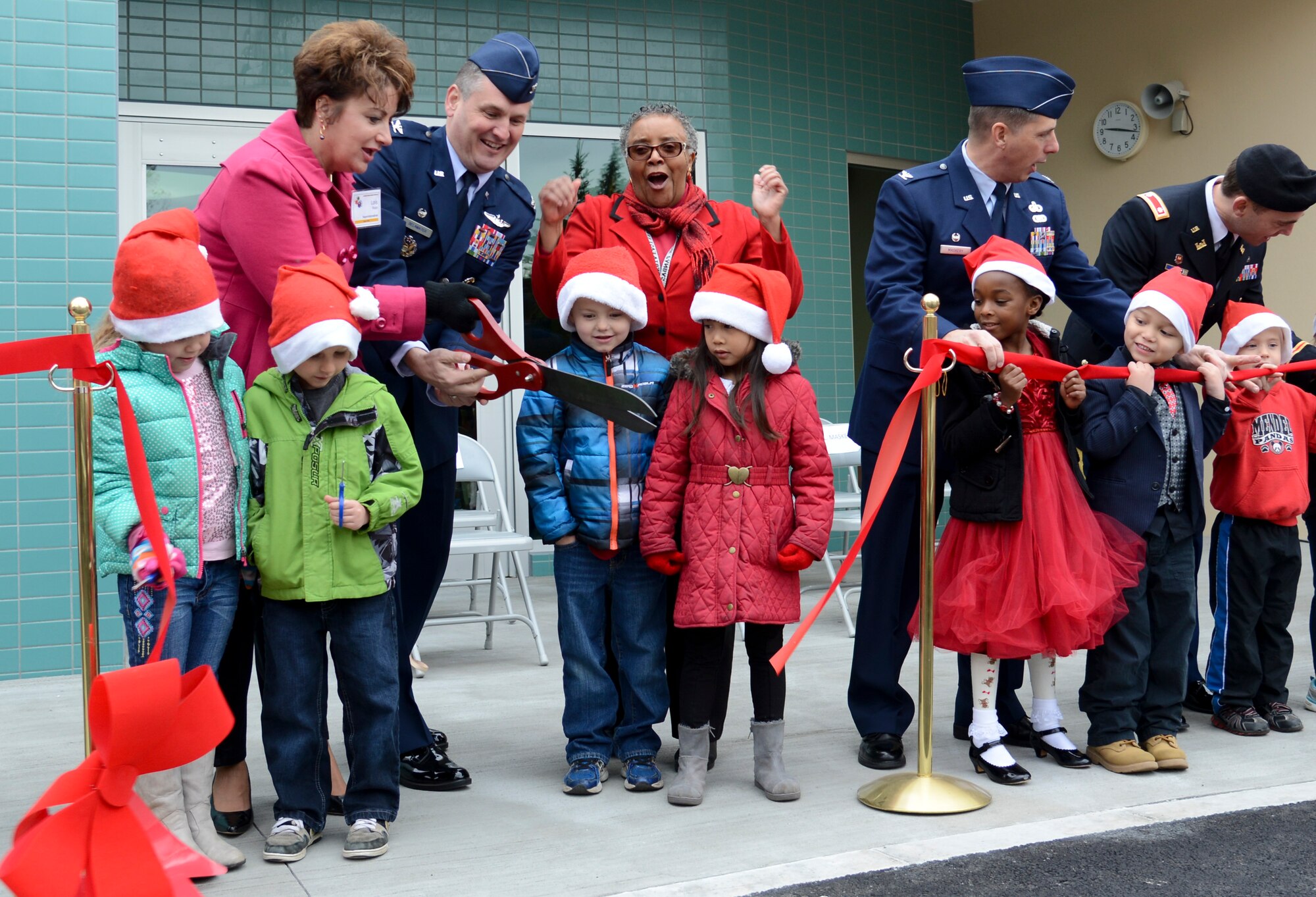 Key members of Yokota Air Base, Japan, cut the ribbon to celebrate the opening of Joan K. Mendel Elementary School’s new Kindergarten building Dec. 12, 2014. Throughout the process of creating the new building, Mrs. Hattie Phipps, school principal, worked hand-in-hand with the architectural company to ensure the building had everything the school needed. (U.S. Air Force photo by Senior Airman Michael Washburn/Released)