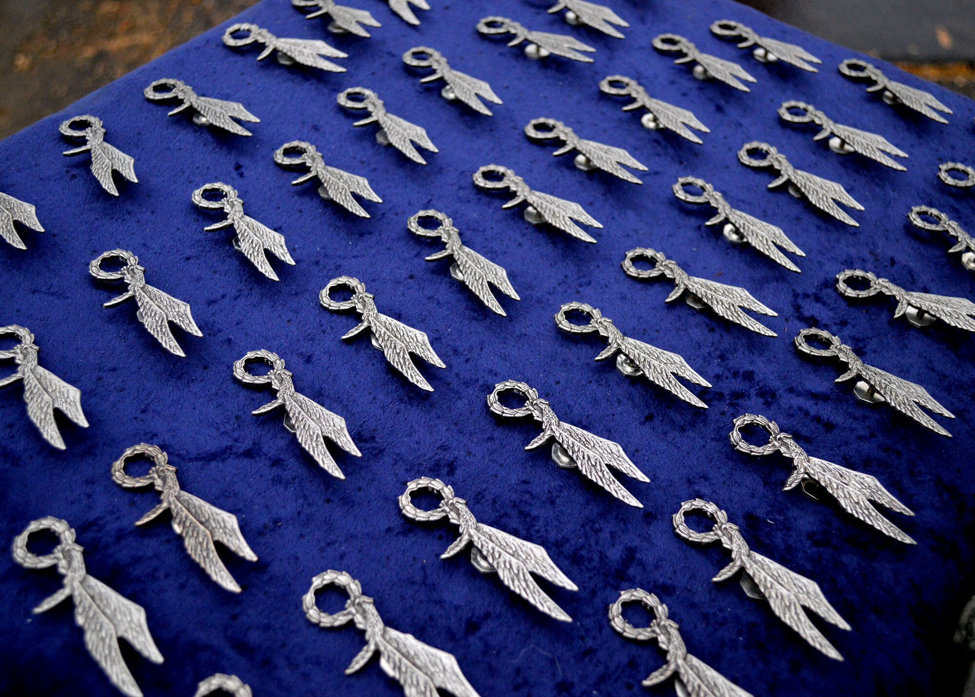 Polish army parachute badges are prepared for presentation to U.S. Army paratroopers at Sicily Drop Zone during the 17th Annual Randy Oler Memorial Operation Toy Drop on Dec. 6 at Fort Bragg, North Carolina. Operation Toy Drop is the world’s largest combined airborne operation where Soldiers donate a toy to receive a lottery ticket number that are then randomly drawn for an opportunity to train and jump with foreign jumpmasters over Sicily Drop Zone. Foreign jumpmasters from Poland, Italy, Latvia, Germany, Indonesia and the Netherlands participated in this year’s event. Last year, Operation Toy Drop collected more than 12,000 toys that were donated to local charities and organizations across North Carolina. (U.S. Air Force photo/Marvin Krause)